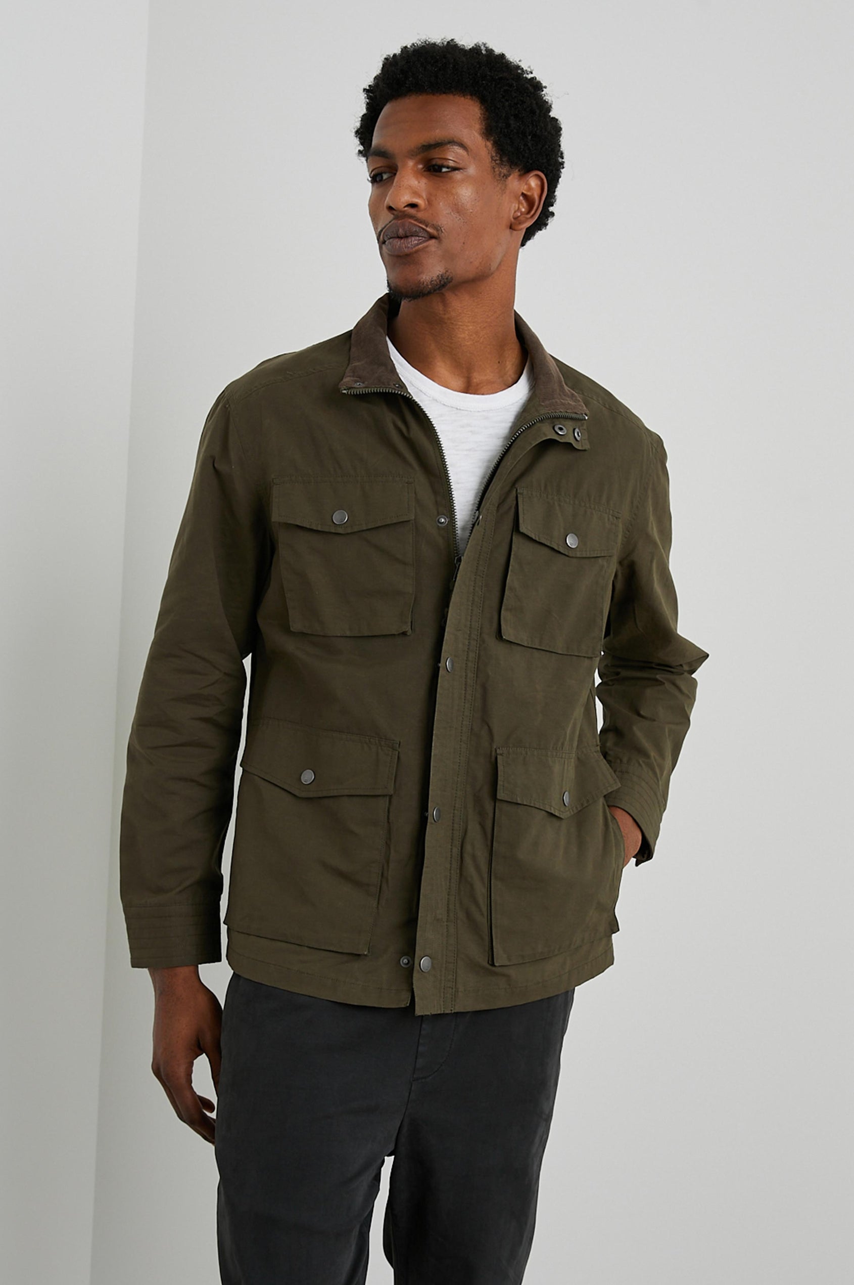 Cardiff Jacket with a Snap and Zipper Closure, Two Chest Snap Flap Pockets and Two Front Snap Flap Pockets in Dark Olive Colorway, with an Interior of Multicolor Horizontal Stripes - Front View Featured on Model  