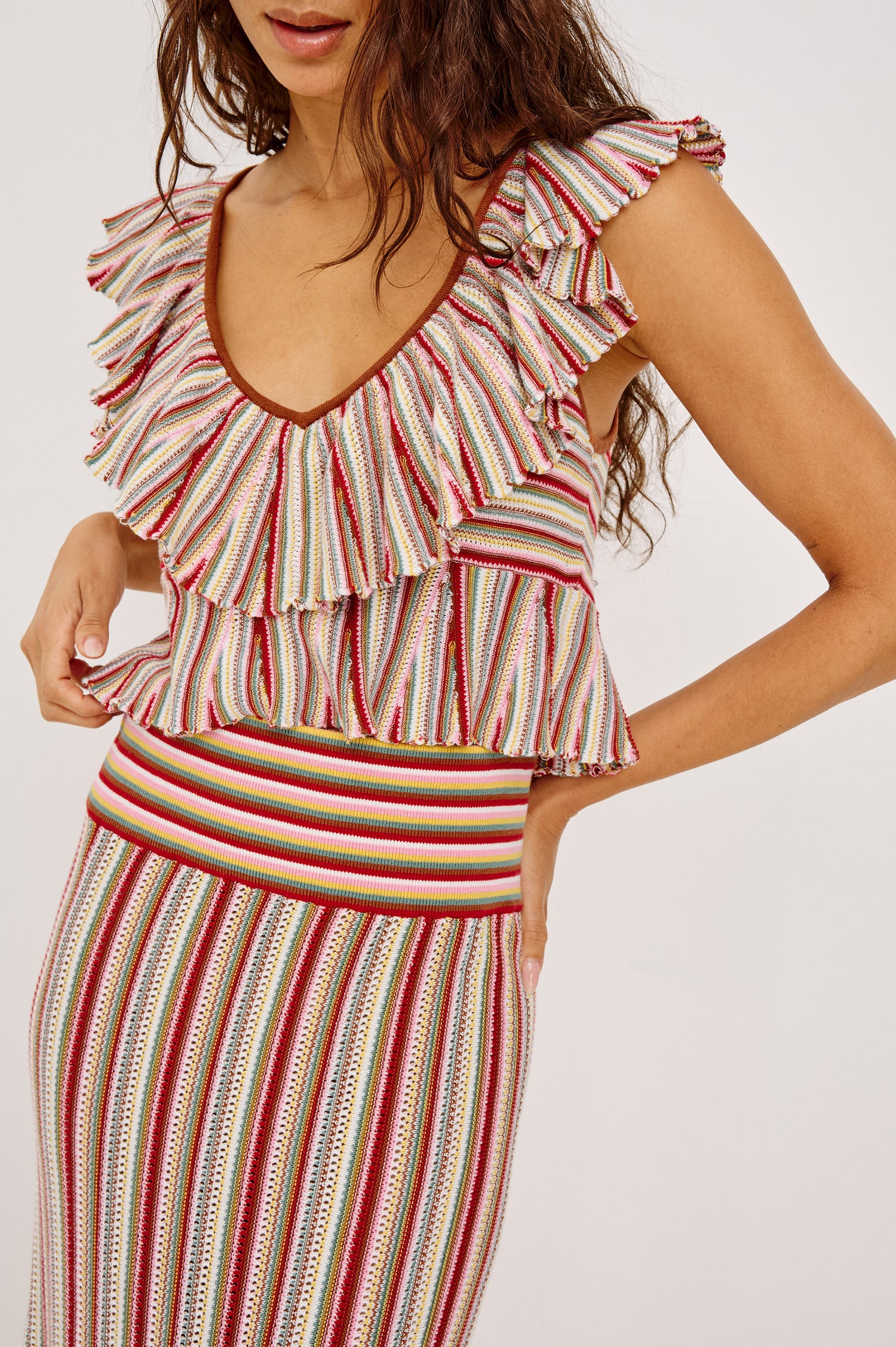 Carmelita Crop Top in Crochet Knit With Ruffle V-Neckline, Fitted Bodice, and Peplum Hem in Havana Stripe Colorway - Upper Body Front View Featured on Model