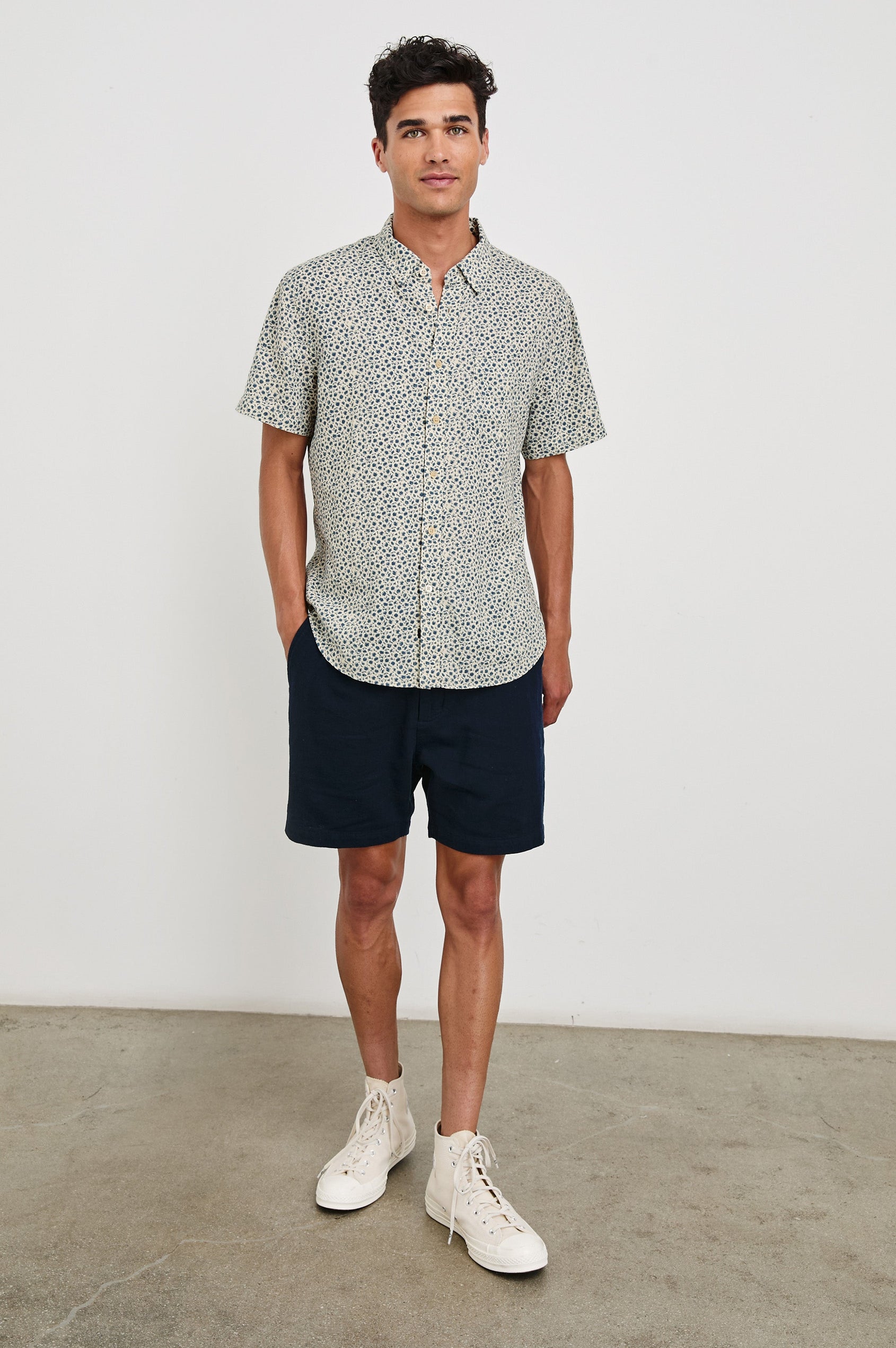 Carson linen short sleeve button down with a collar and blue botanical pattern in Autumn Daisy Ocean - full body front view on model