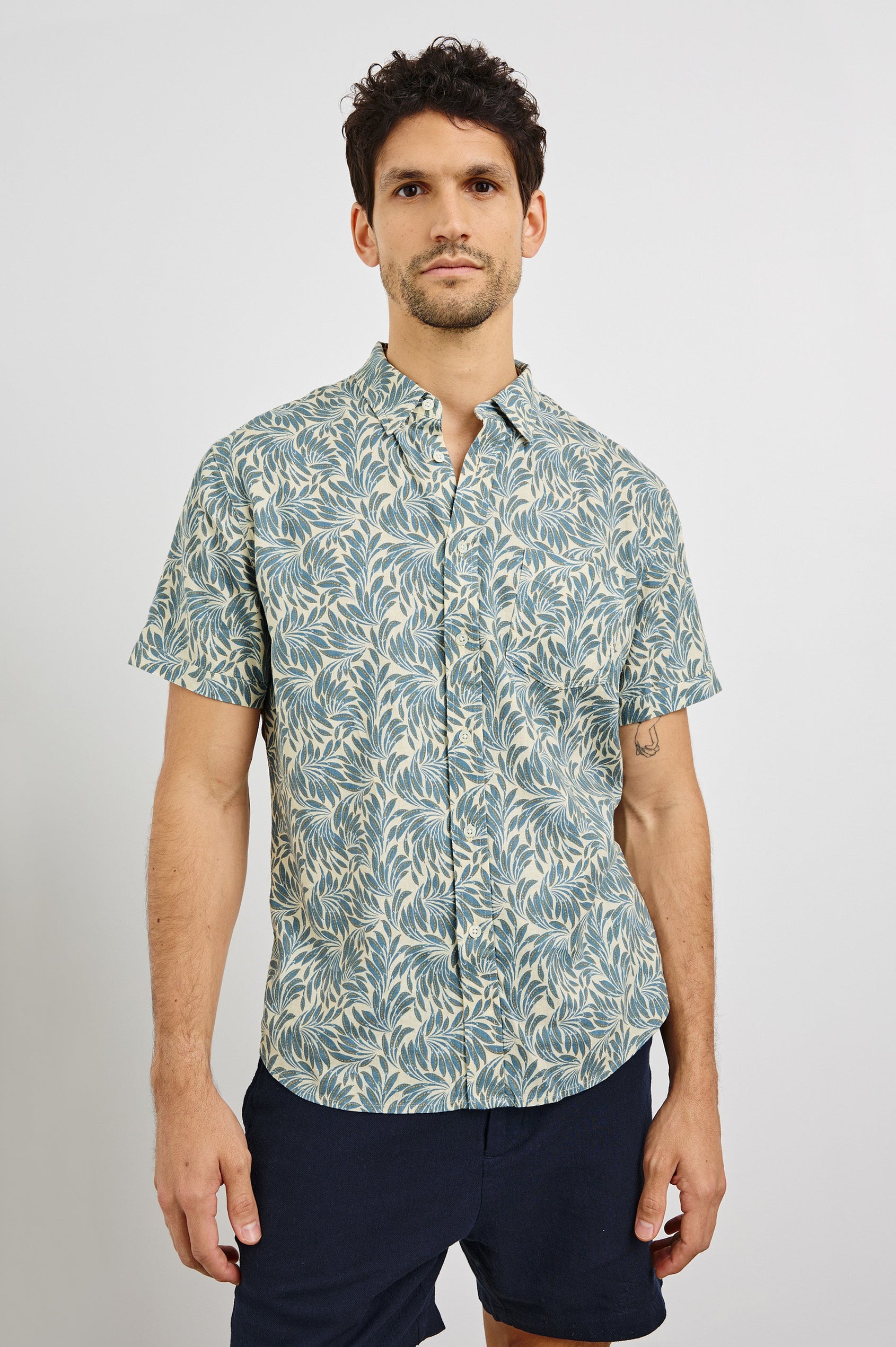 Carson Collared Button Front Shirt with Short Sleeves and a Chest Pocket in Ecru Banana Leaf Colorway. Front View Shown on Model.