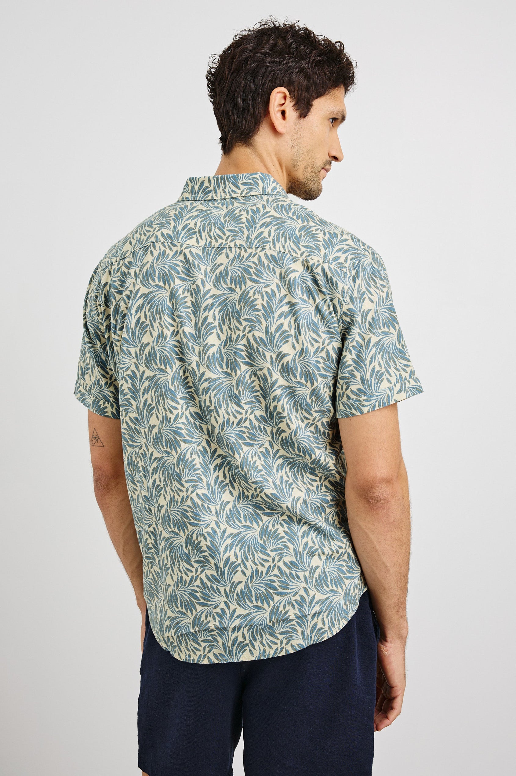 Carson Collared Button Front Shirt with Short Sleeves and a Chest Pocket in Ecru Banana Leaf Colorway. Back View Shown on Model.