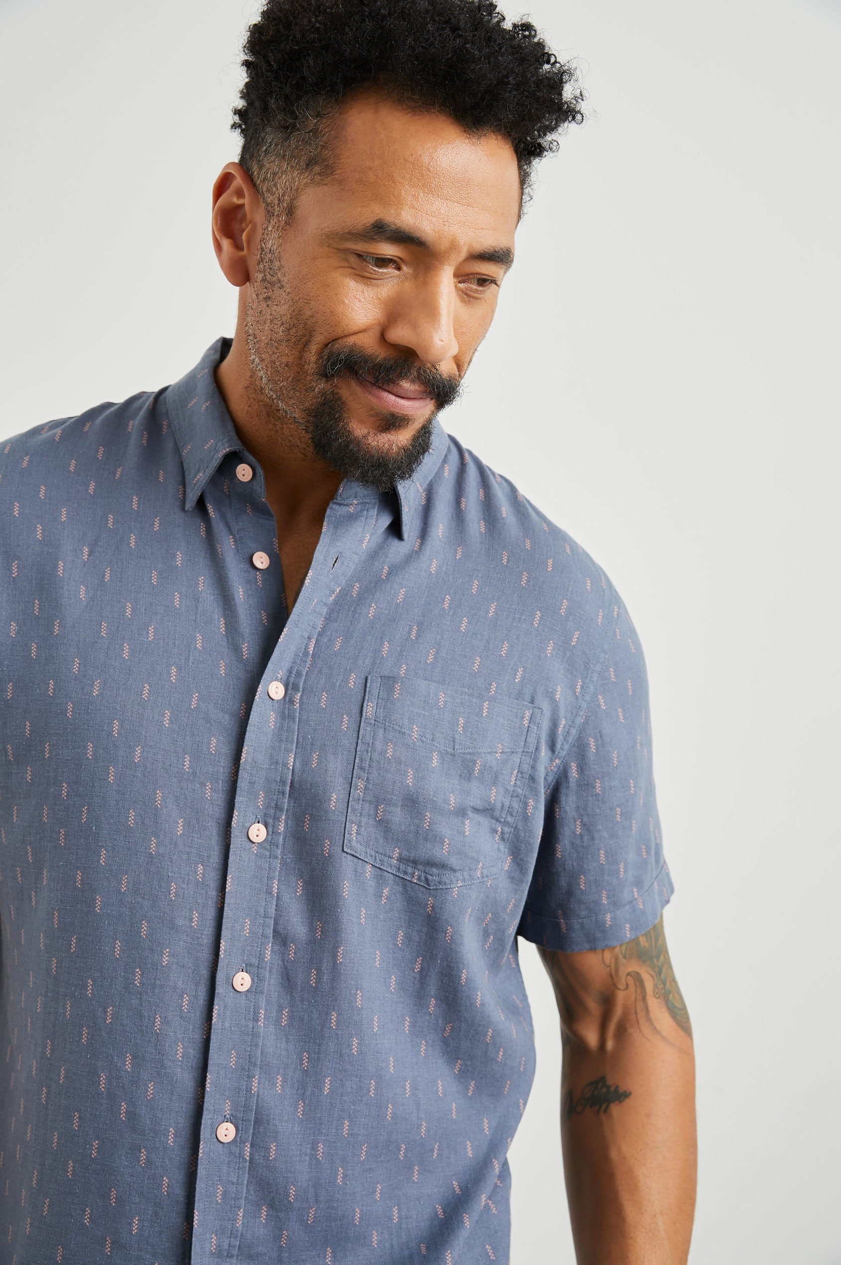 Carson Short Sleeve Button Up with a Chest Patch Pocket in Louis Leaf Slate Colorway, Small Tan and White Leaves on Slate- Front View Featured on Model
