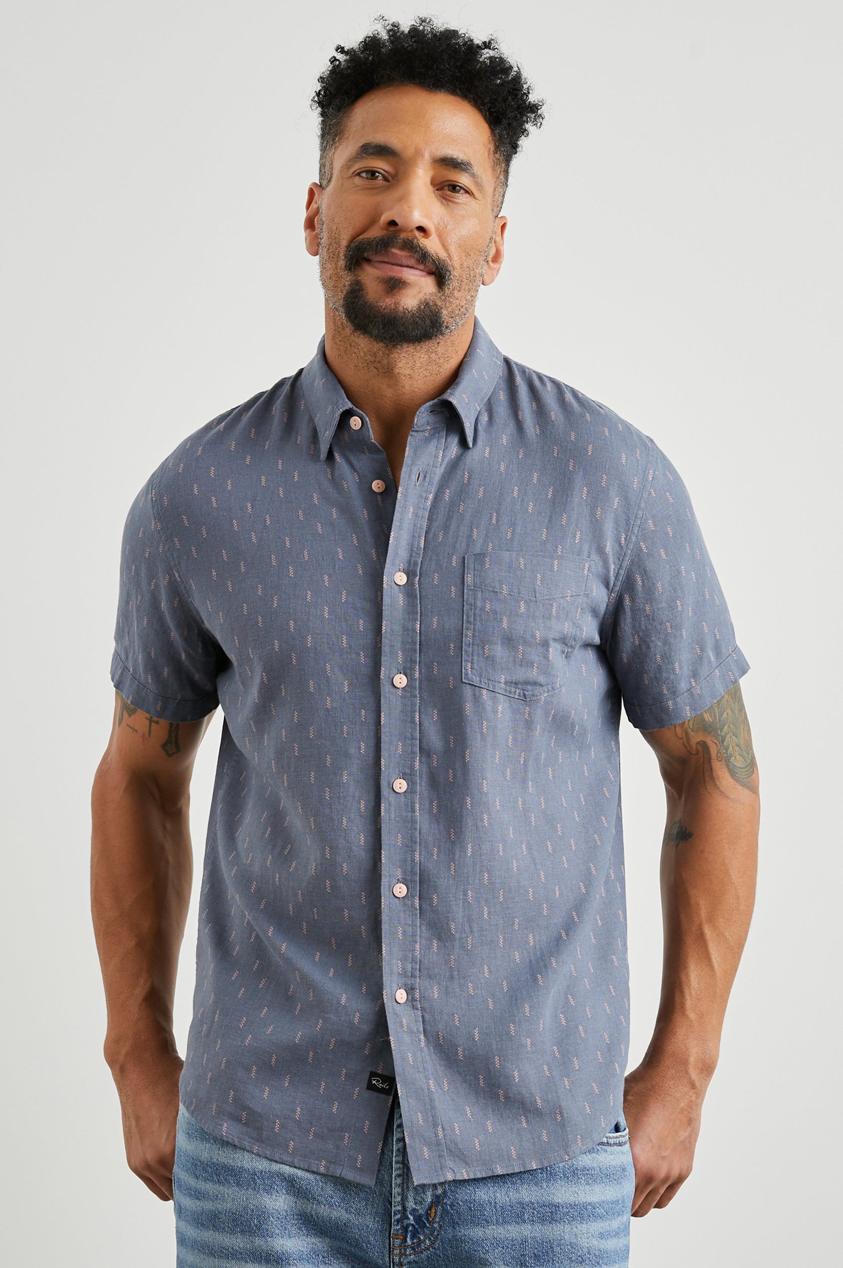 Carson Short Sleeve Button Up with a Chest Patch Pocket in Louis Leaf Slate Colorway, Small Tan and White Leaves on Slate- Front View Featured on Model