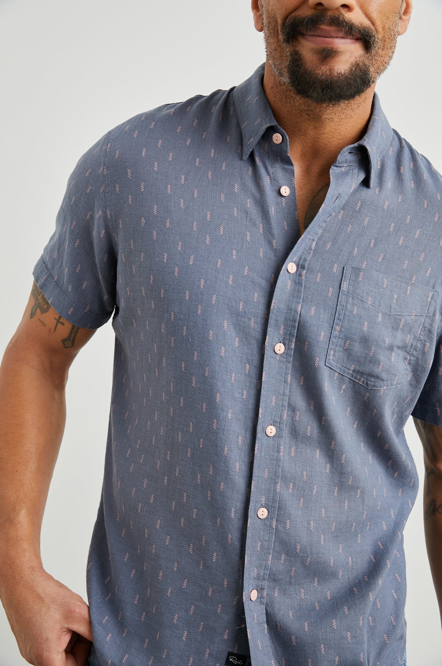 Carson Short Sleeve Button Up with a Chest Patch Pocket in Louis Leaf Slate Colorway, Small Tan and White Leaves on Slate- Front View Featured on Model