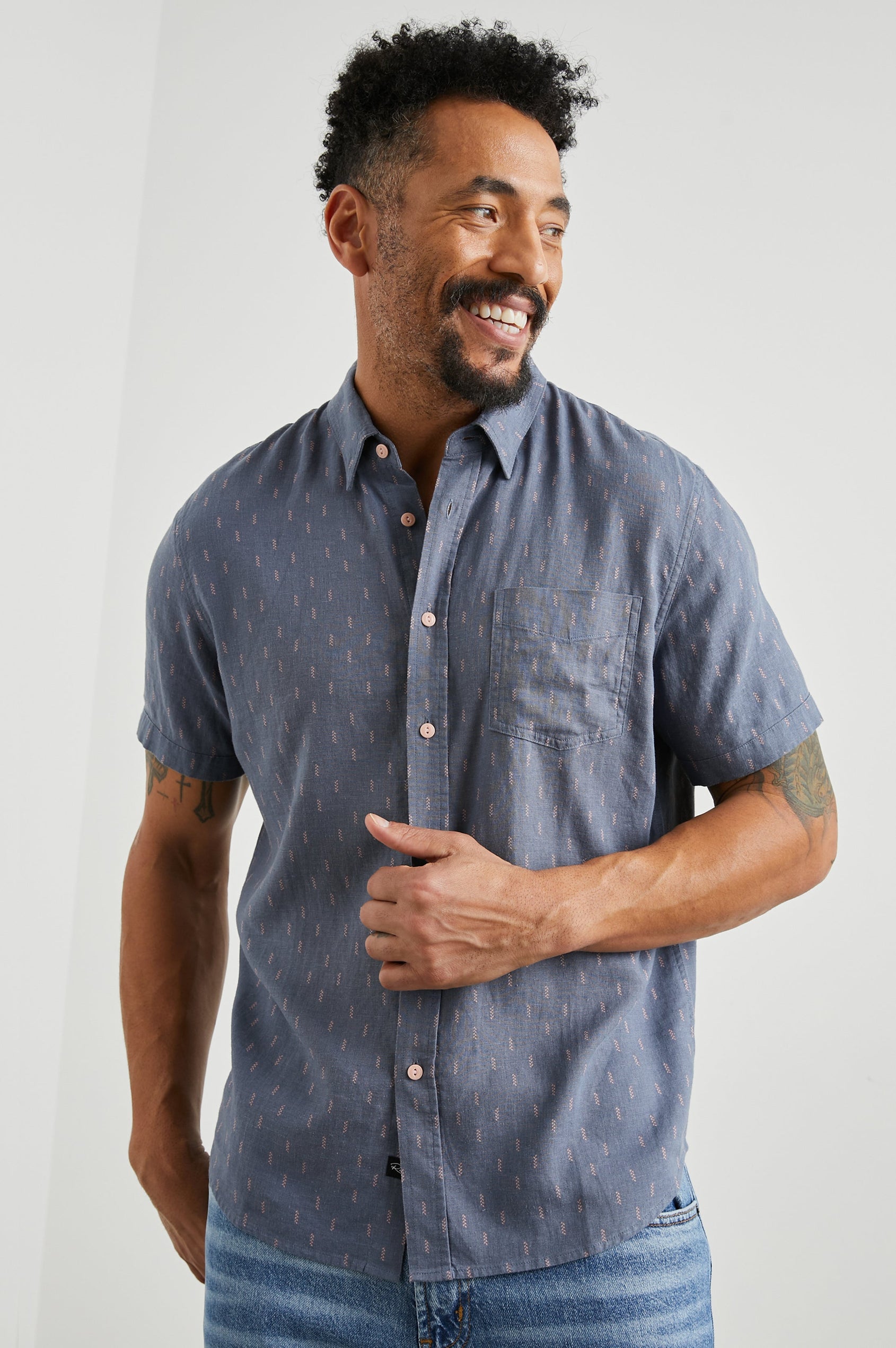Carson Short Sleeve Button Up with a Chest Patch Pocket in Louis Leaf Slate Colorway, Small Tan and White Leaves on Slate- Front View Featured on Model