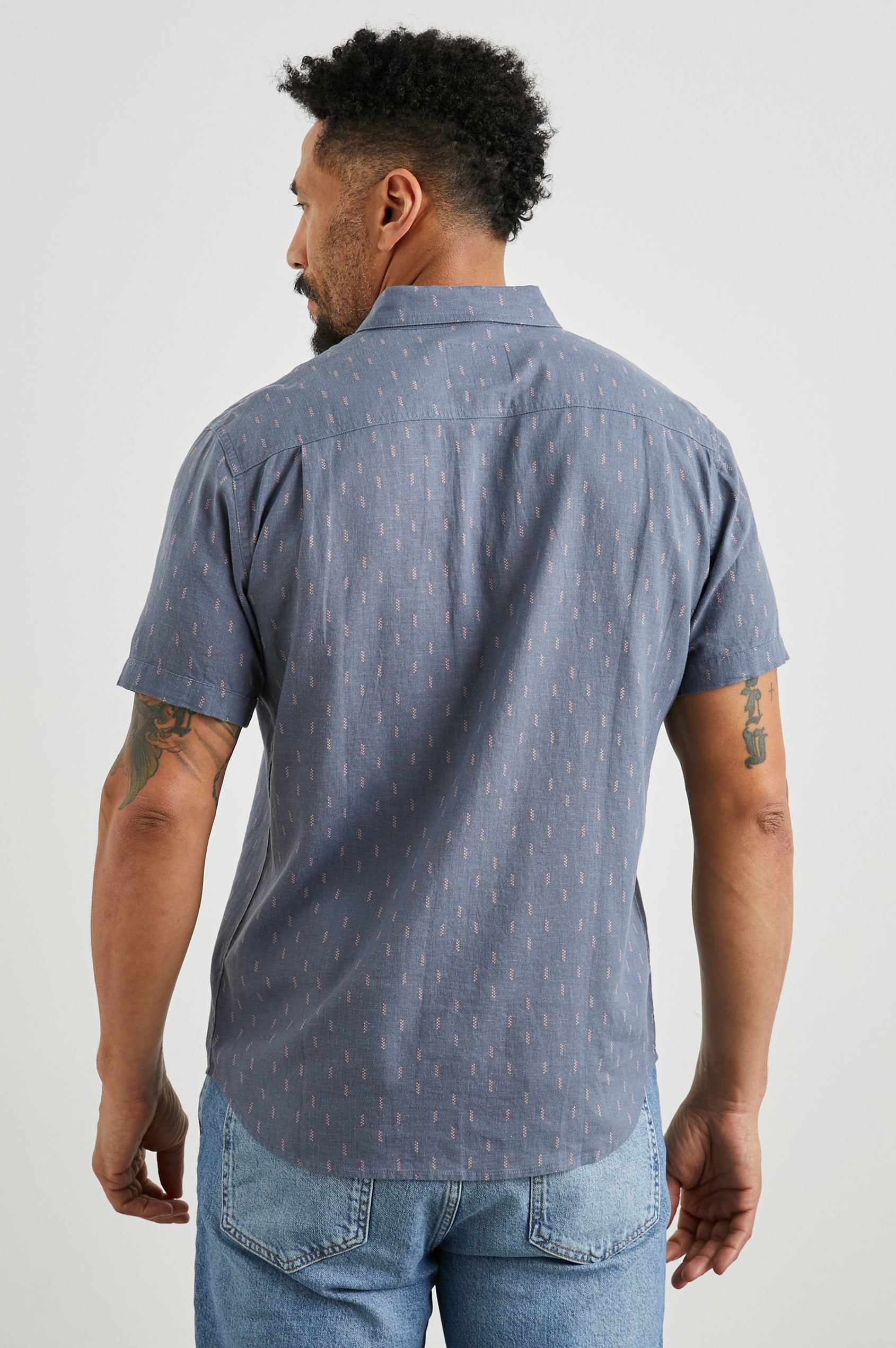 Carson Short Sleeve Button Up with a Chest Patch Pocket in Louis Leaf Slate Colorway, Small Tan and White Leaves on Slate- Back View Featured on Model