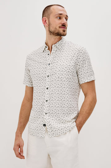 Carson Collared Button Front Shirt with Short Sleeves and a Chest Pocket in Nervous Leaf White Colorway. Front View Shown on Model.