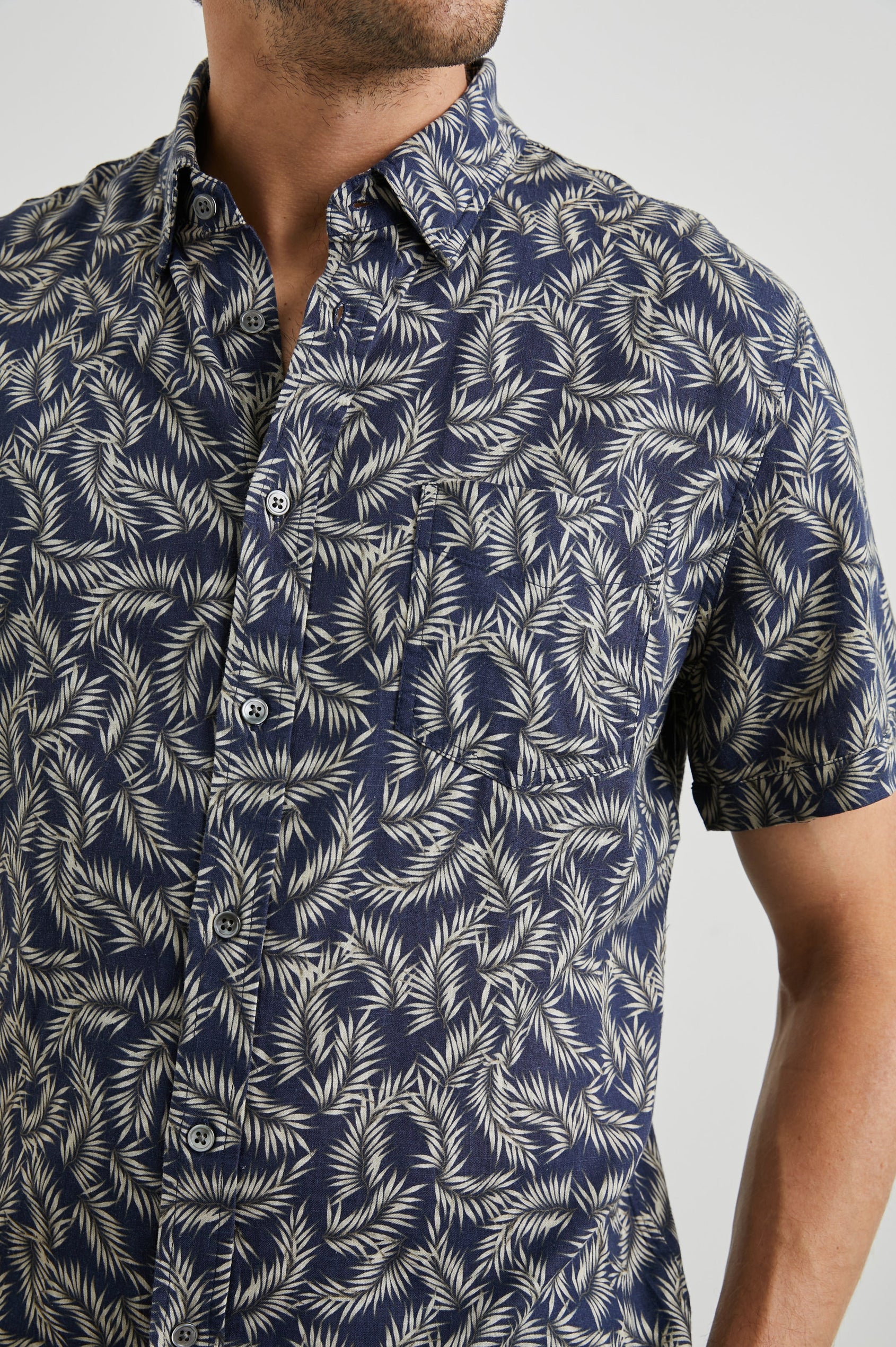 Carson Short Sleeve Button Up with a Chest Patch Pocket in Palm American Navy Colorway, Tan Fronds on Navy - Front View Featured on Model