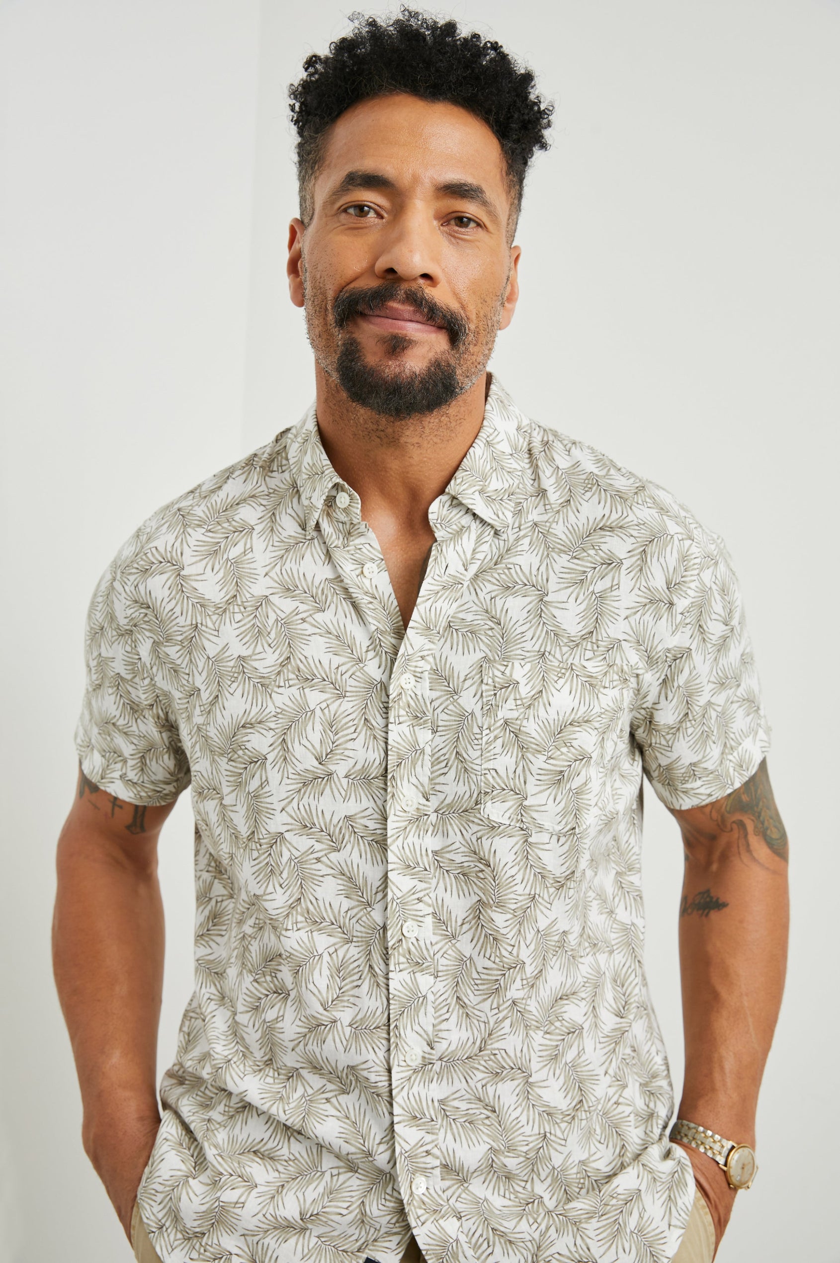 Carson Short Sleeve Button Up with a Chest Patch Pocket in Palm American White Colorway, Olive Fronds on White - Front View Featured on Model