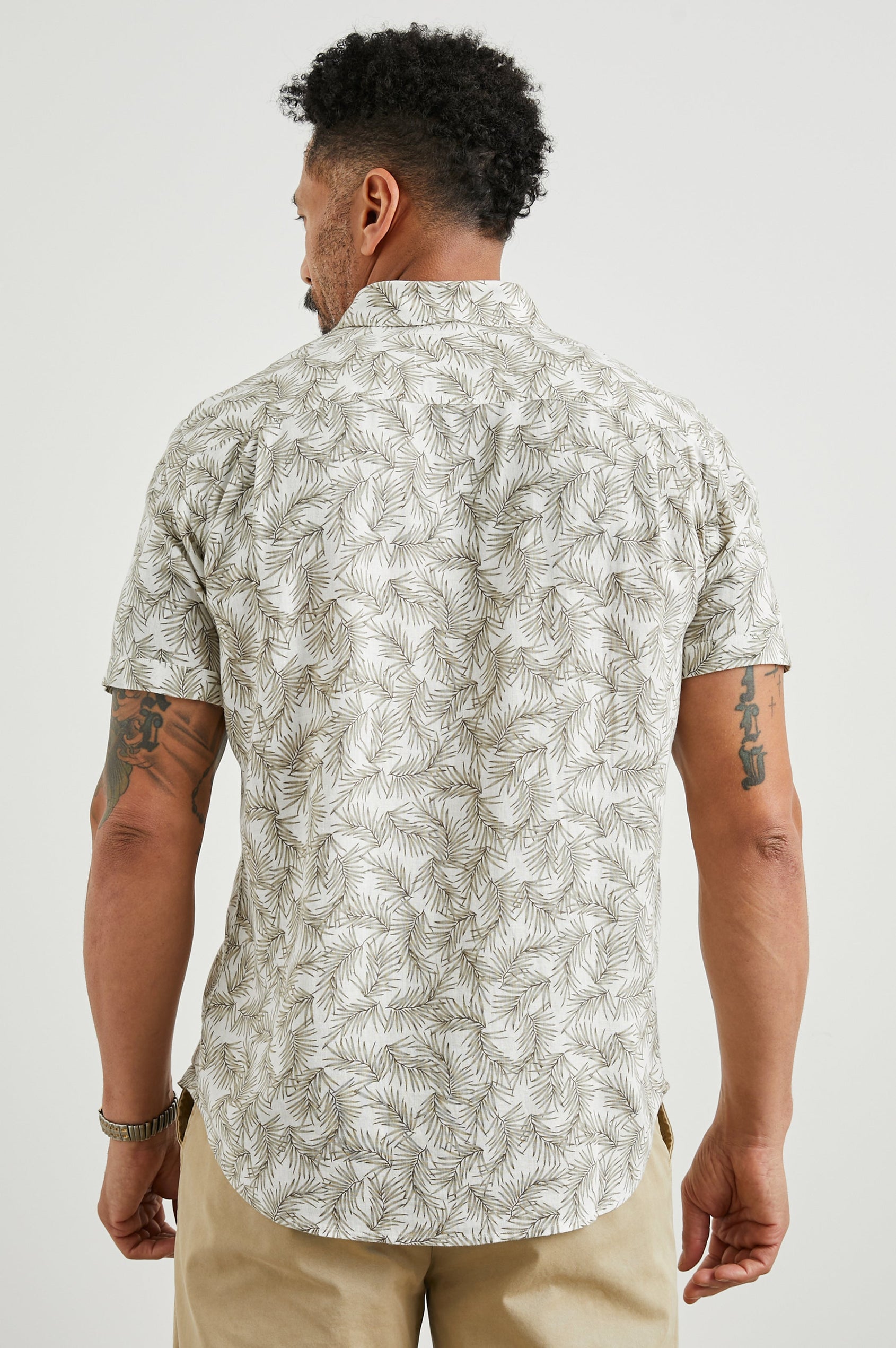 Carson Short Sleeve Button Up with a Chest Patch Pocket in Palm American White Colorway, Olive Fronds on White - Back View Featured on Model