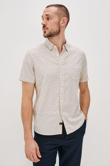Carson linen short sleeve button down with a collar and front chest pocket in Petite Fronds Hummus colorway - front view on model