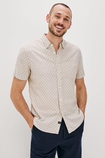 Carson linen short sleeve button down with a collar and front chest pocket in Petite Fronds Hummus colorway - front view on model