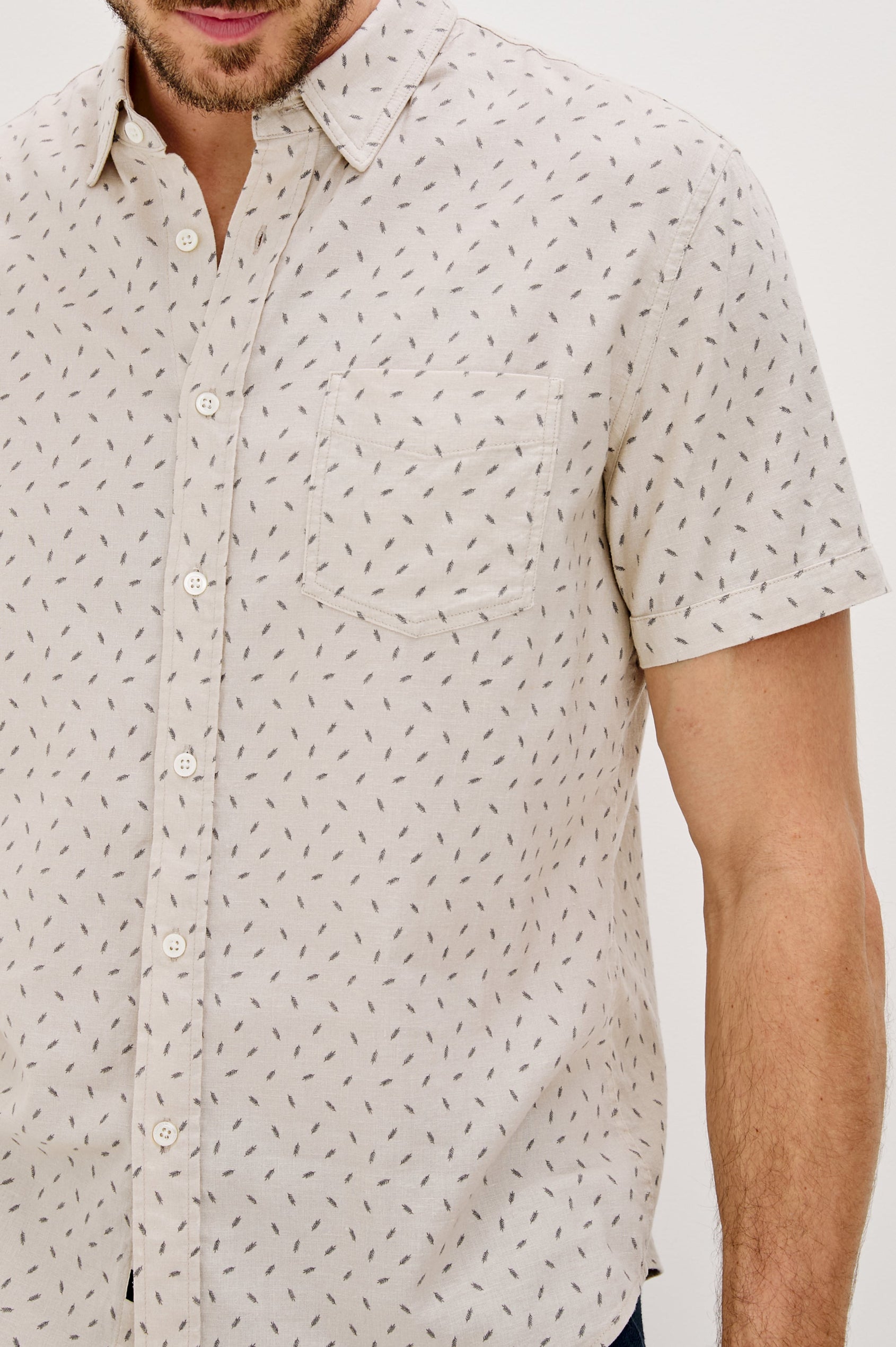 Carson linen short sleeve button down with a collar and front chest pocket in Petite Fronds Hummus colorway - front detail view on model