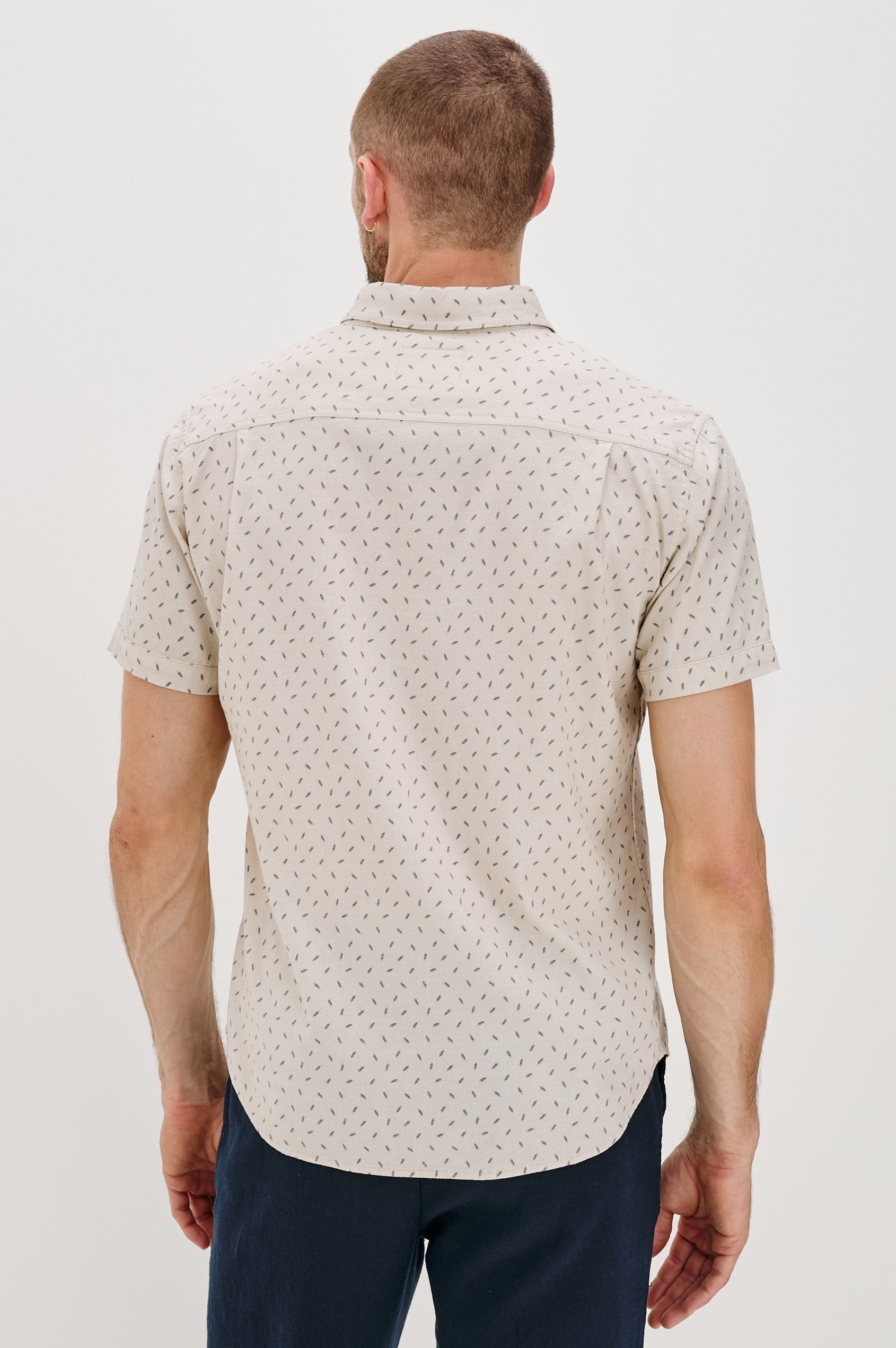 Carson linen short sleeve button down with a collar and front chest pocket in Petite Fronds Hummus colorway - back view on model