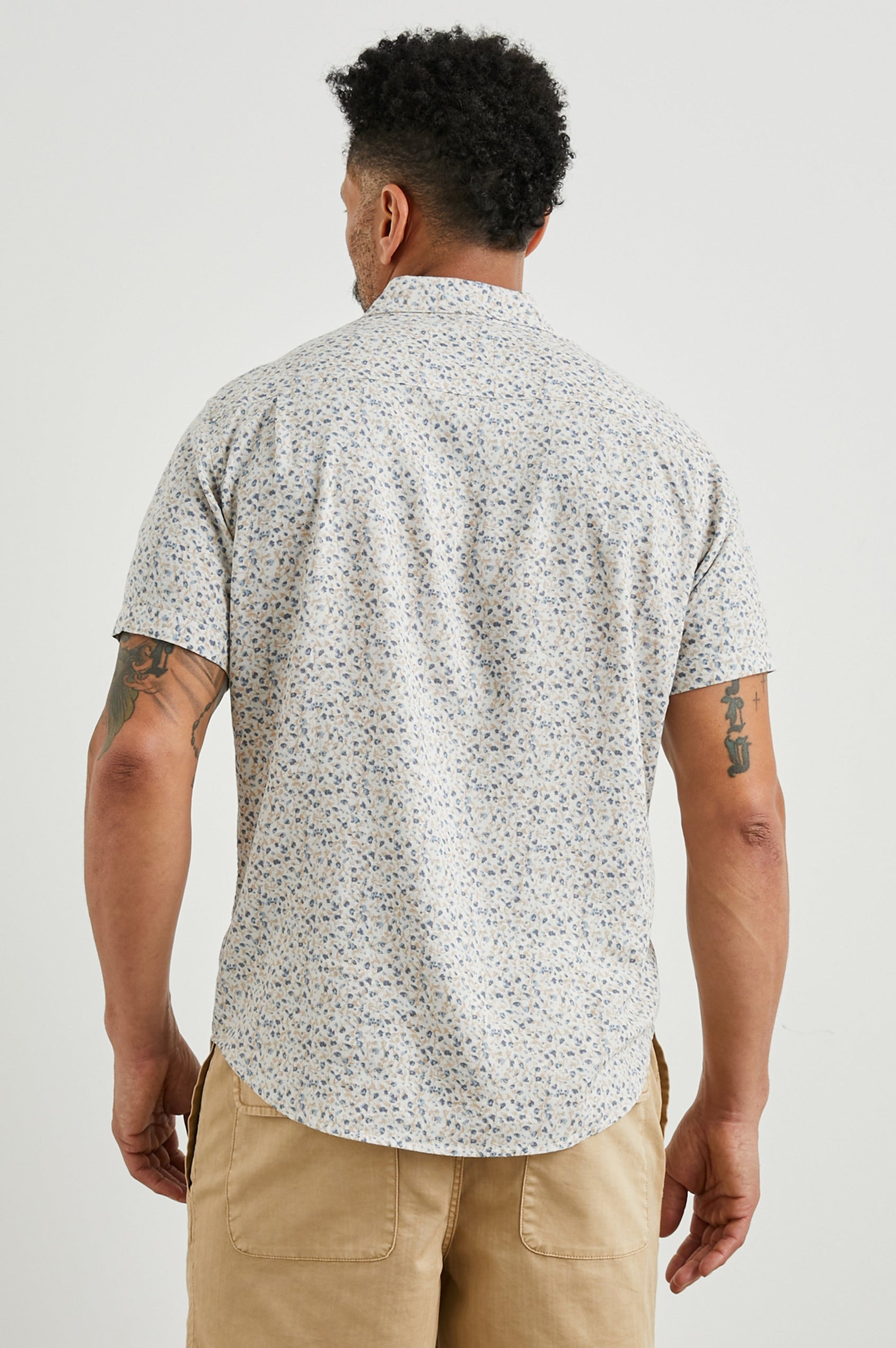 Carson Short Sleeve Button Up with a Chest Patch Pocket in Spring Blossom Parchment Colorway, Blossoms in Blue and Tan on Parchment - Back View Featured on Model