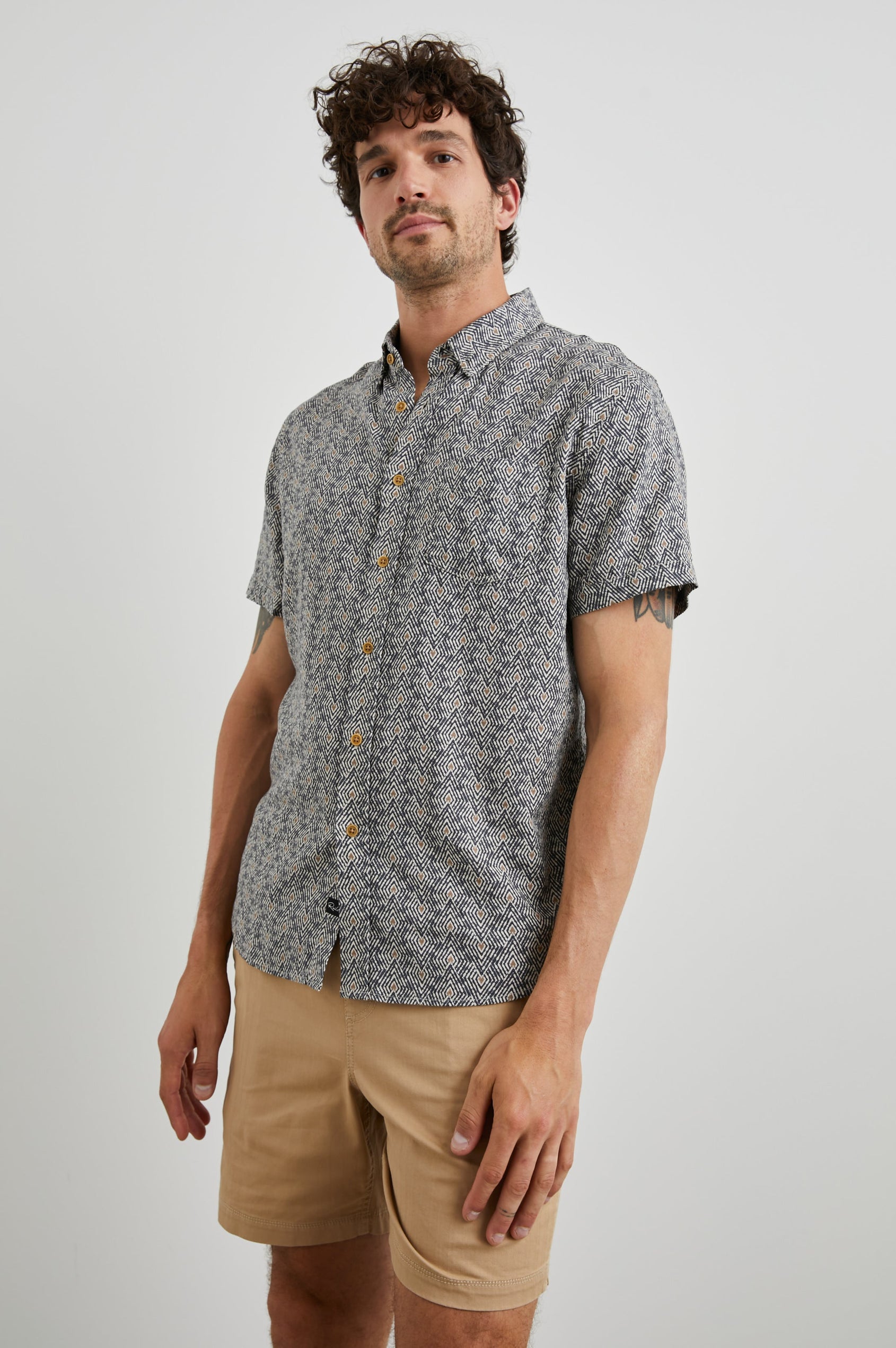 Carson Short Sleeve Button Up with a Chest Patch Pocket in Tribal Batik Celestial Colorway, Geometric Black, Tan and White Pattern - Front View Featured on Model