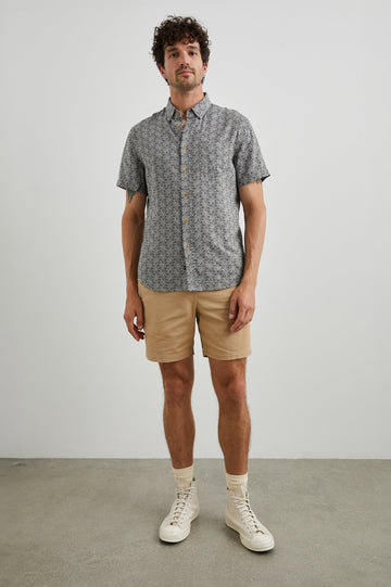 Carson Short Sleeve Button Up with a Chest Patch Pocket in Tribal Batik Celestial Colorway, Geometric Black, Tan and White Pattern - Front Full Body View Featured on Model