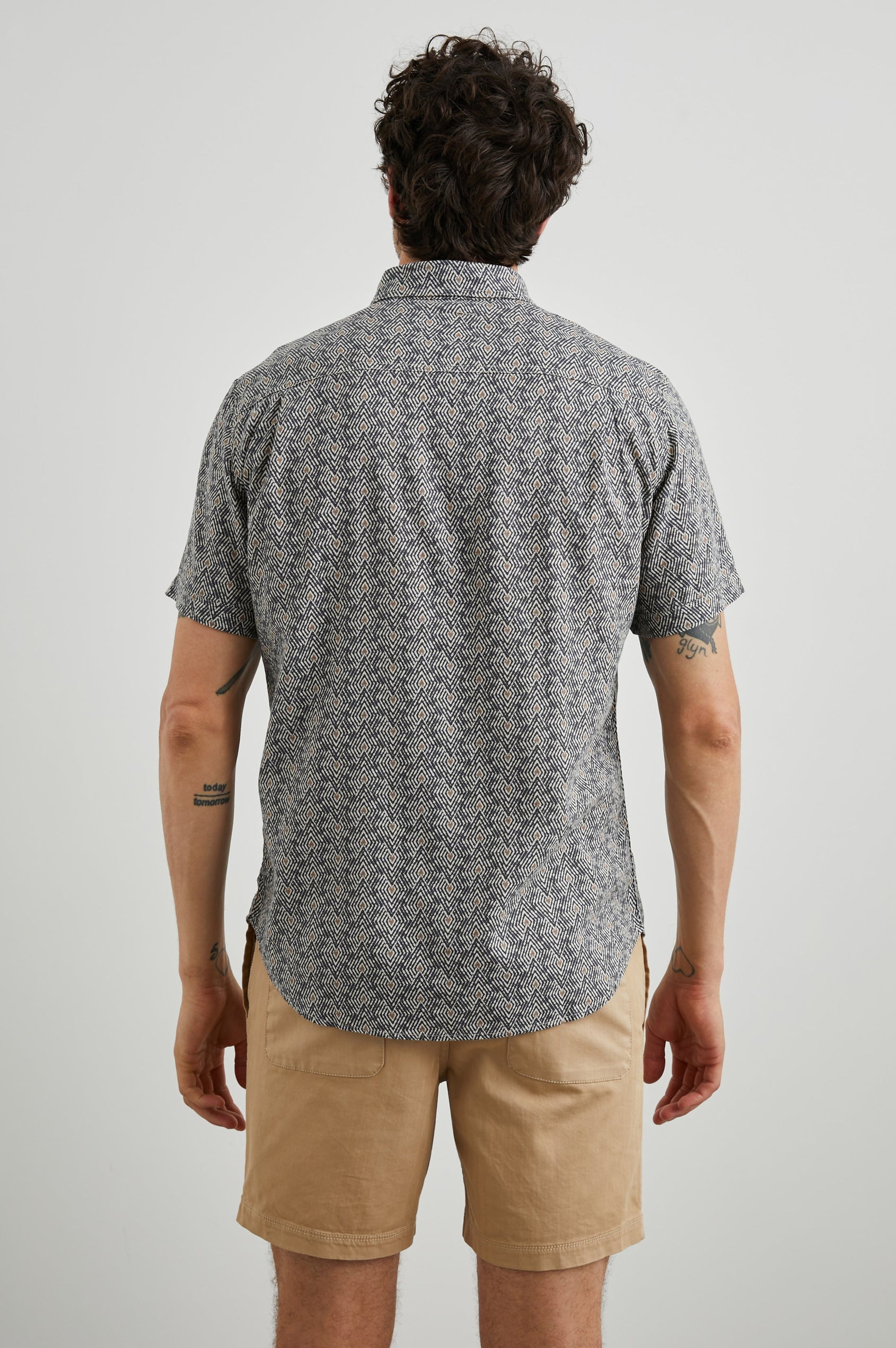 Carson Short Sleeve Button Up with a Chest Patch Pocket in Tribal Batik Celestial Colorway, Geometric Black, Tan and White Pattern - Back View Featured on Model
