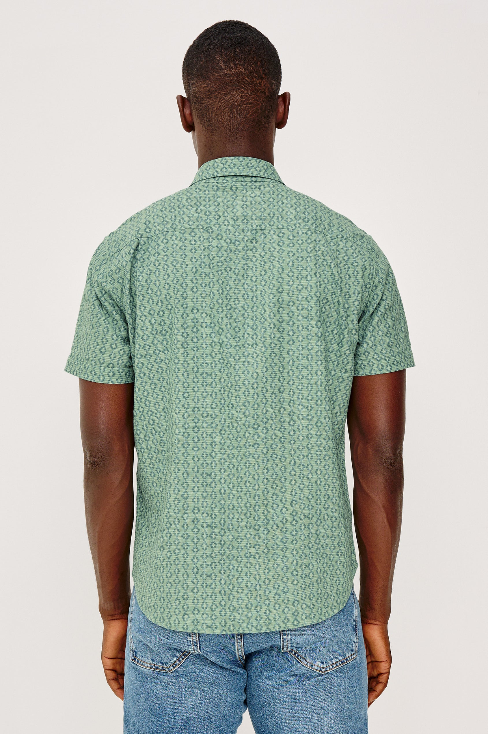 Carson Button Front Shirt in Linen Blend With Collar, Short Sleeves, Chest Patch Pocket, and Classic Fit in Batik Aqua Colorway - Upper Body Back View Featured on Model