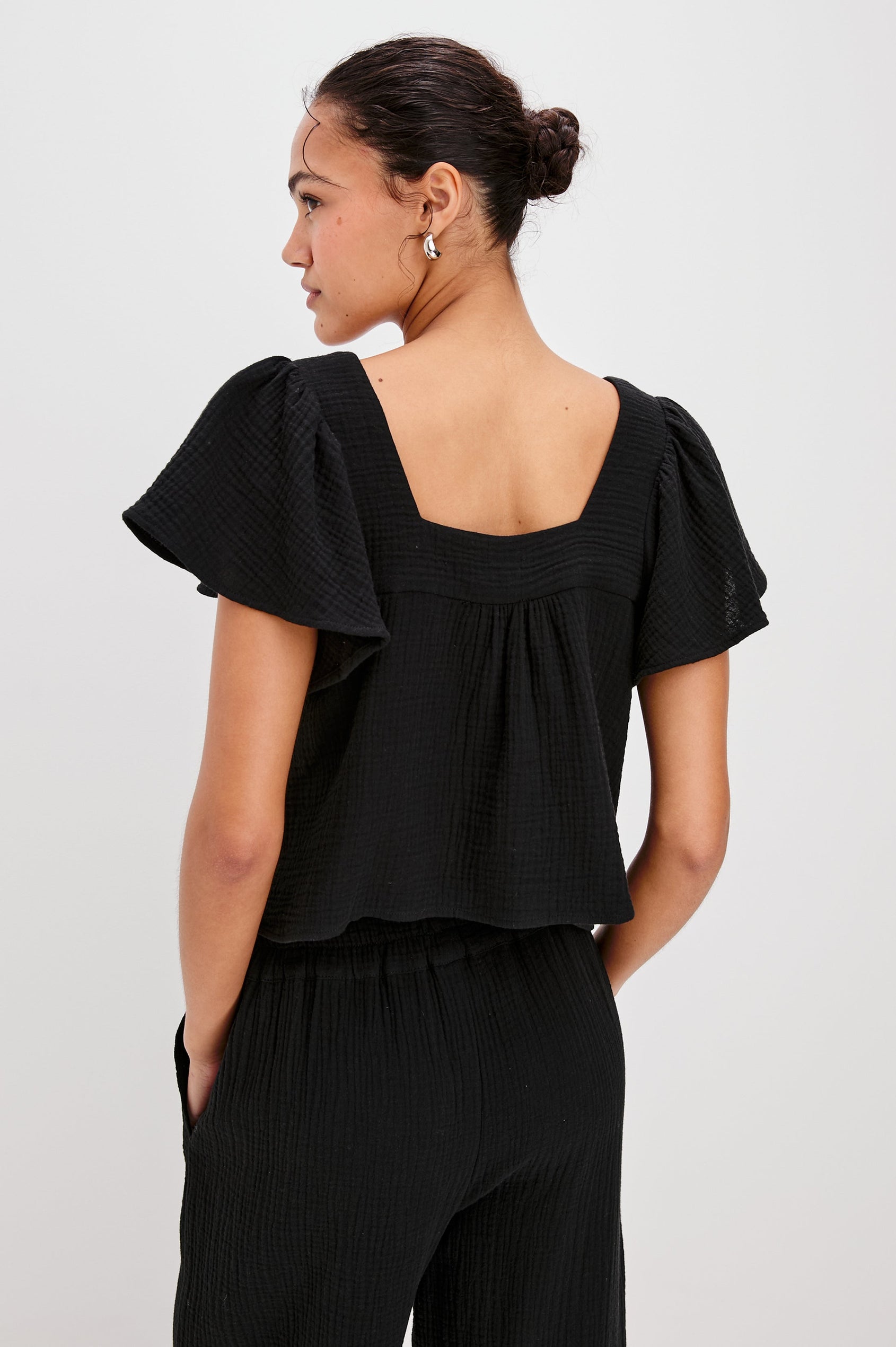 Casie Square Neck Top with Short Flutter Sleeves, V-Cut Center Front with Self Tie in Black Colorway. Back View Shown on Model.