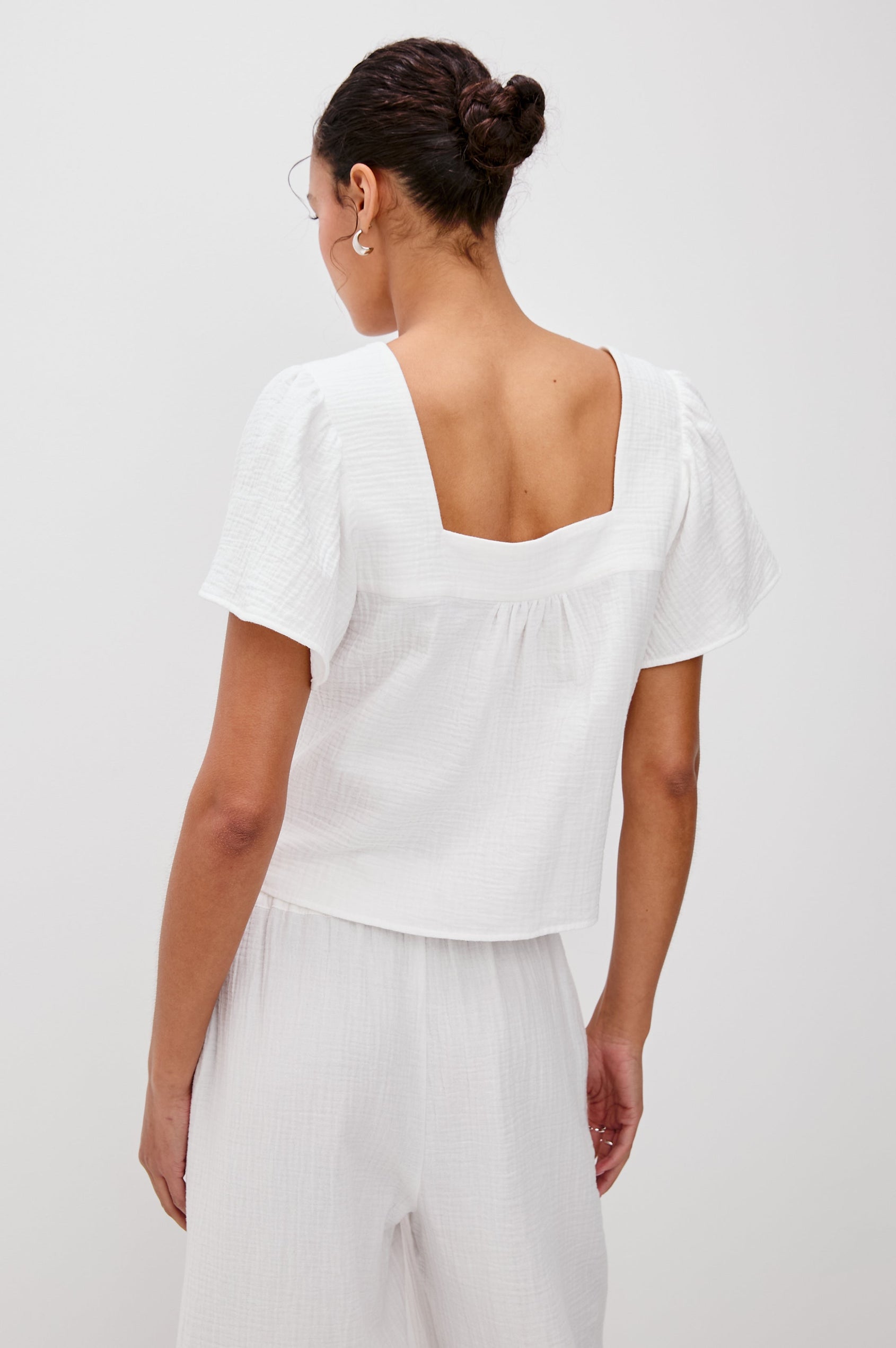 Casie Square Neck Flutter Sleeve Top with a V-Tie Front in White Colorway. Back View Shown on Model.