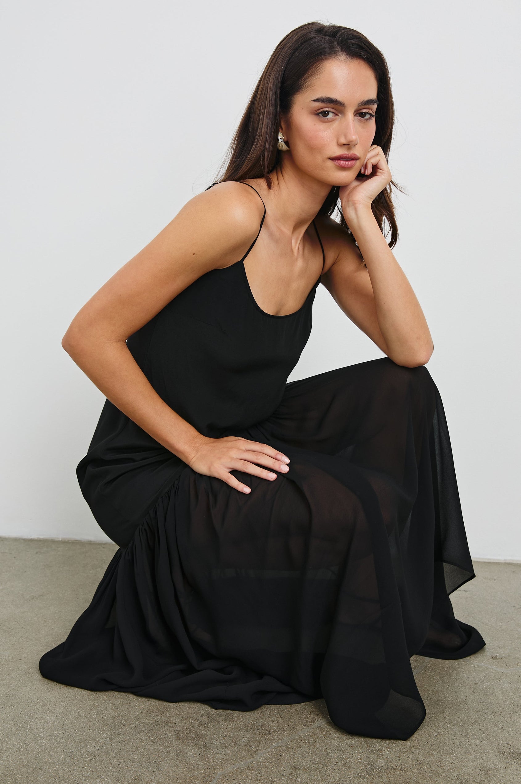 Chandra Maxi Tank Dress with Spaghetti Straps and a Contrast Semi Sheer Fabric Gathered Hem in Black Colorway. Front View Shown on Model.