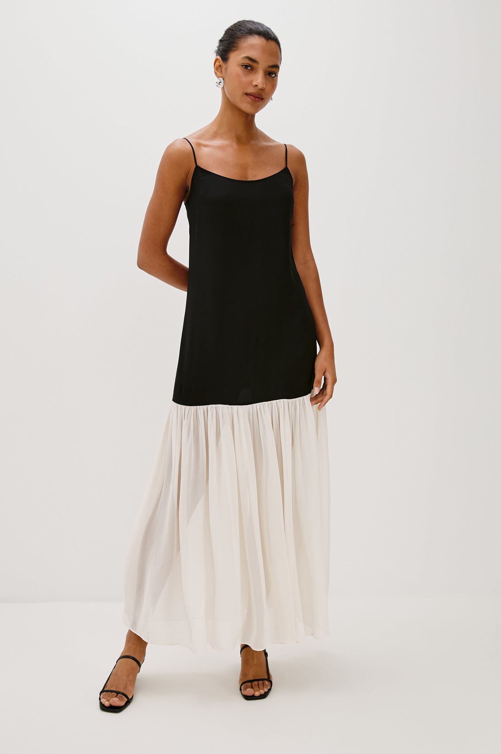 Chandra Maxi Tank Dress with Spaghetti Straps and a Contrast Semi Sheer Fabric Gathered Hem in Black Ivory Colorway - full body front view on model.