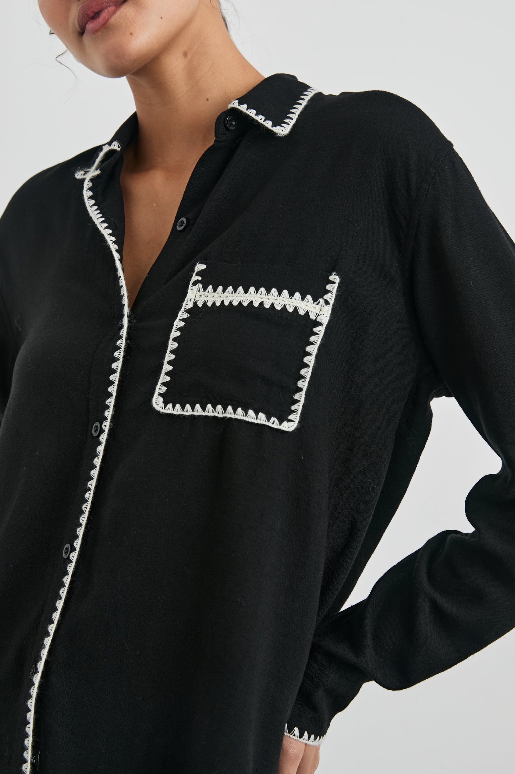 Charli Long-Sleeve Button up with a Chest Patch Pocket in Black Blanket Stitch Colorway, with white blanket stitches on black - Front View Featured on Model