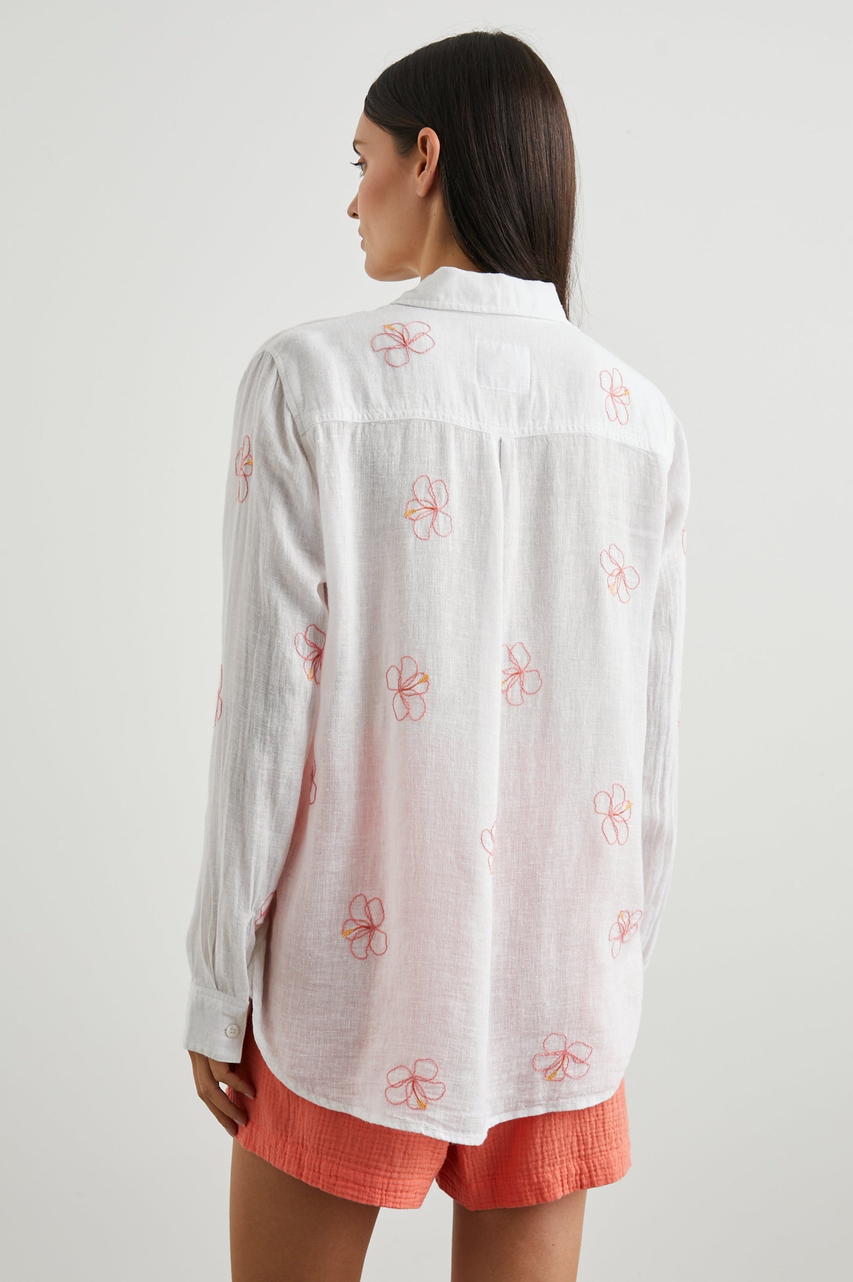 Charli Long-Sleeve Button up with a Chest Patch Pocket in Hibiscus Embroidery Colorway, with Hibiscus on white  - Back View Featured on Model