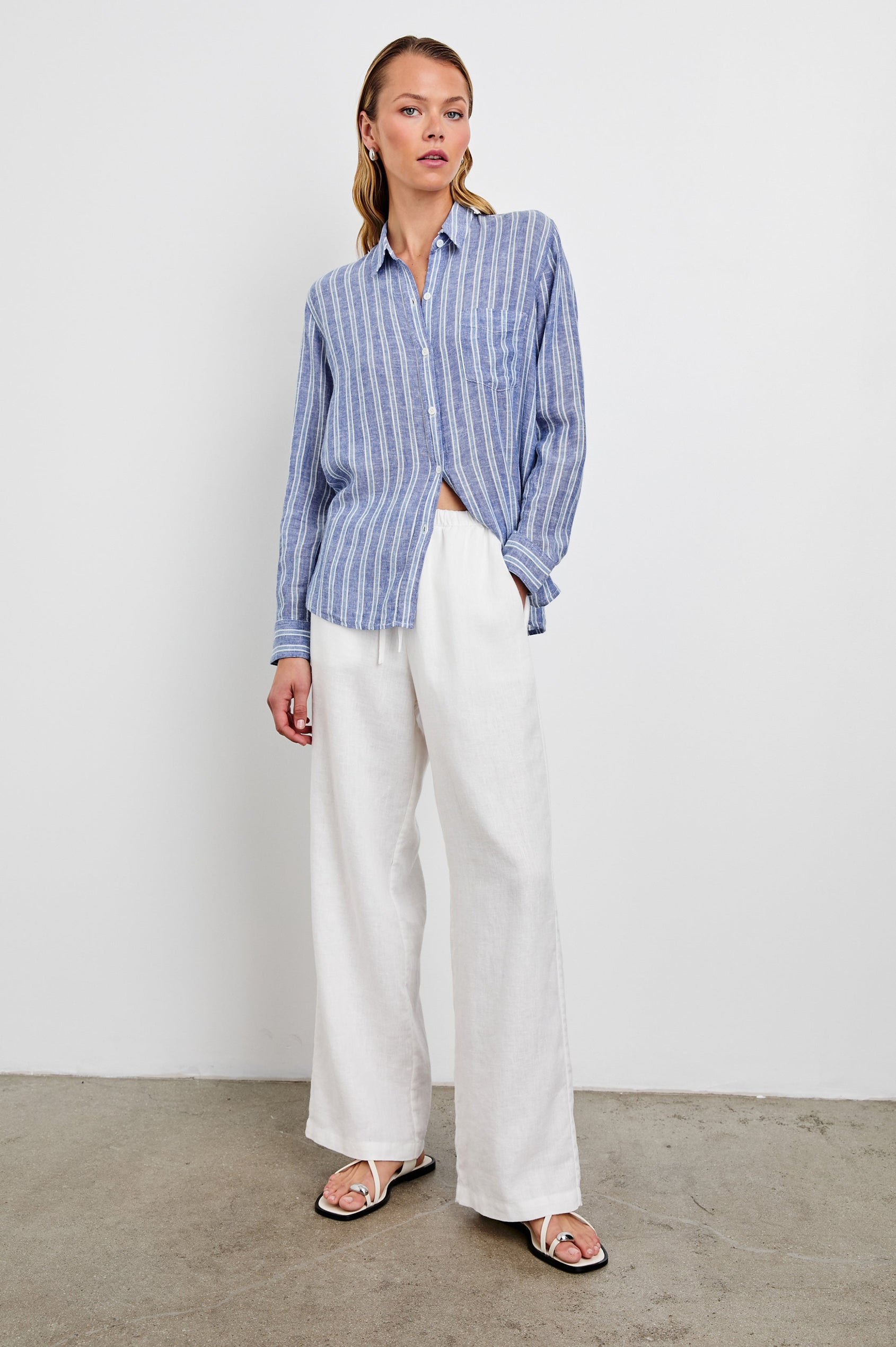 Charli Long-Sleeve Button up with a Chest Patch Pocket in Lake View Stripe Colorway, with alternating light blue and blue stripes, each bordered by white stripes - Front Full Body View Featured on Model