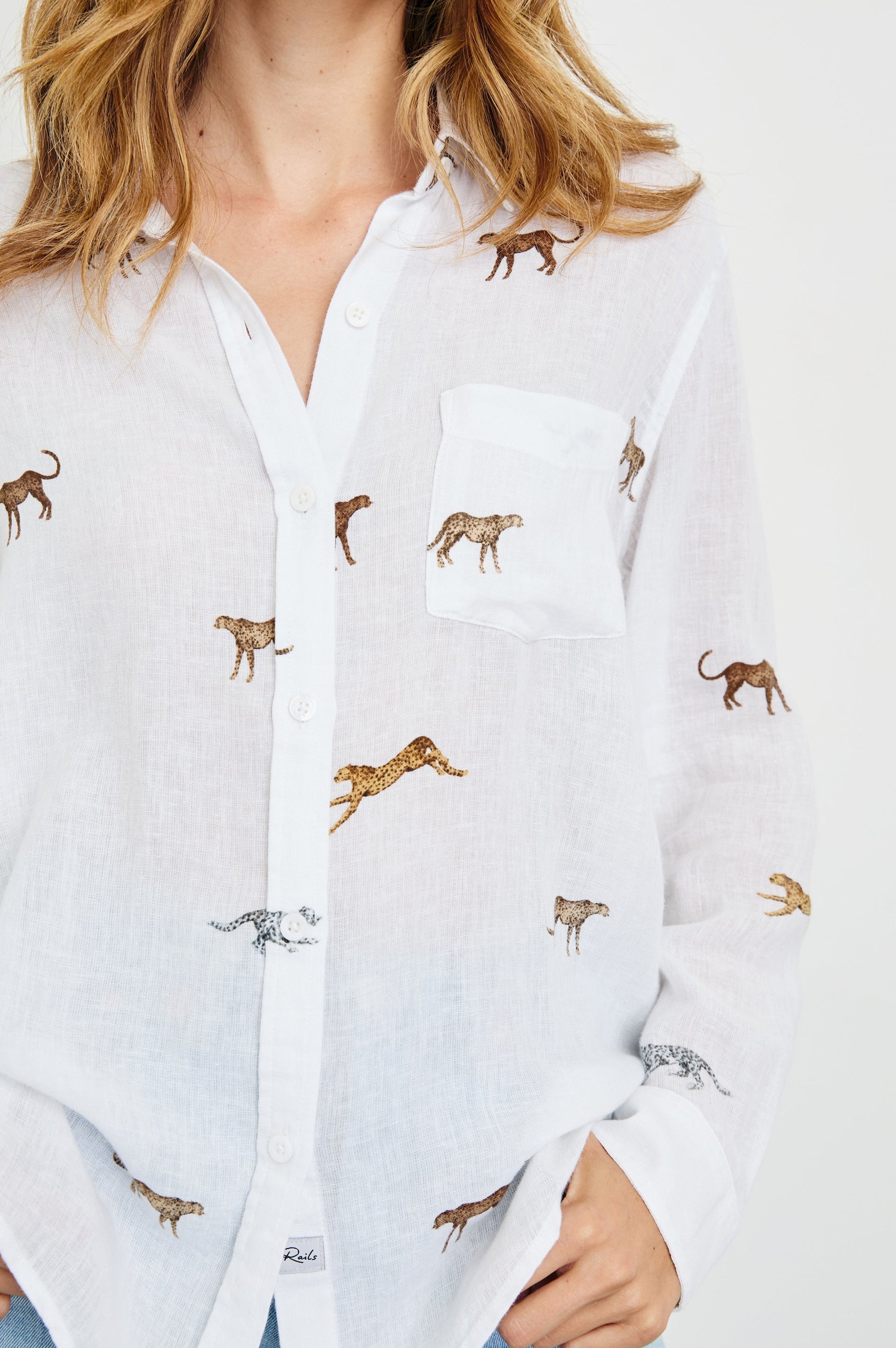 Charli Long-Sleeve Button up with a Chest Patch Pocket in Safari Cheetah Colorway, with cheetahs in browns and white on ivory - Front View Featured on Model