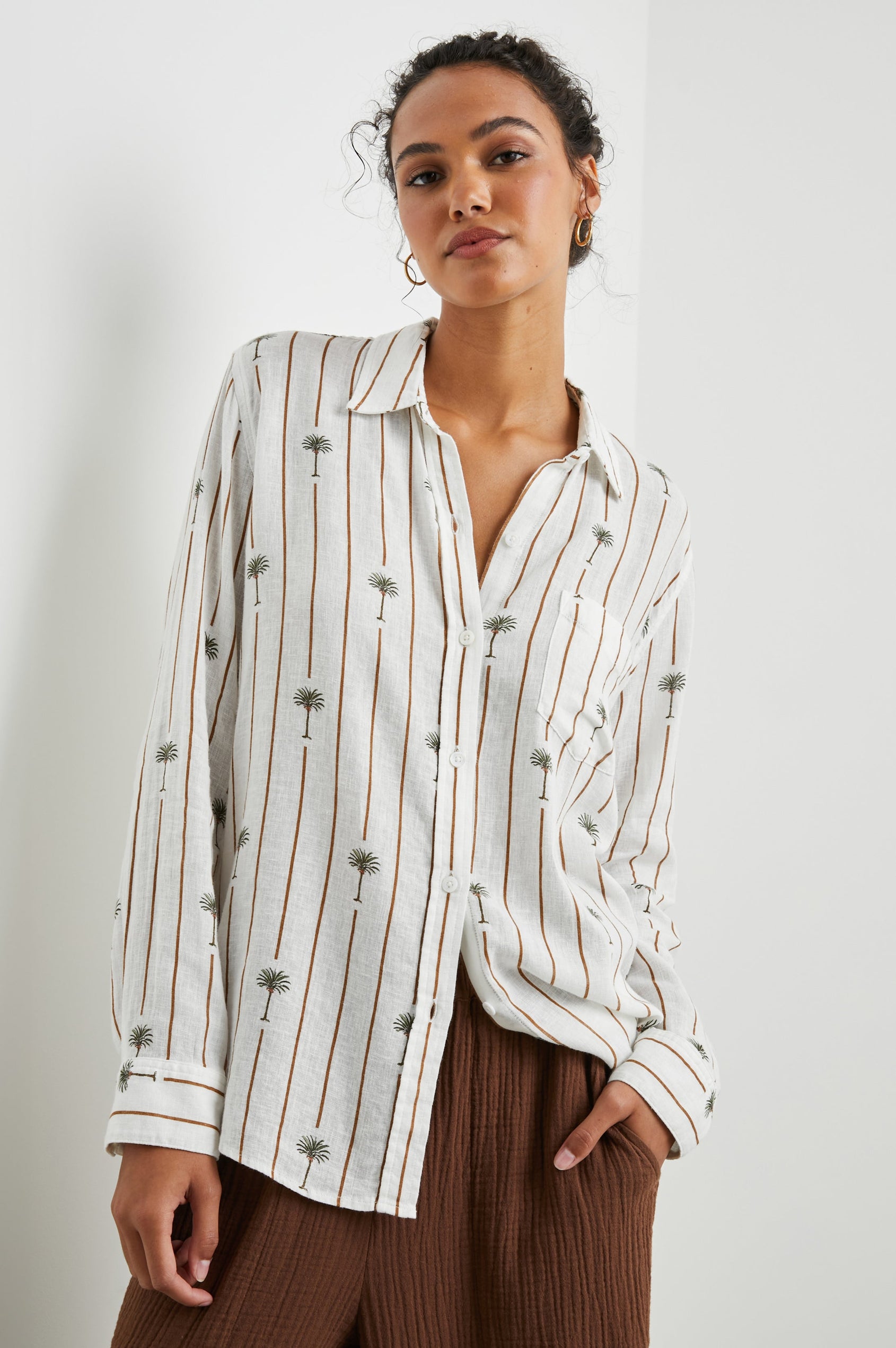 Charli Long-Sleeve Button up with a Chest Patch Pocket in Stripe Palms Colorway, with brown vertical stripes dashed with palm trees on white - Front View Featured on Model