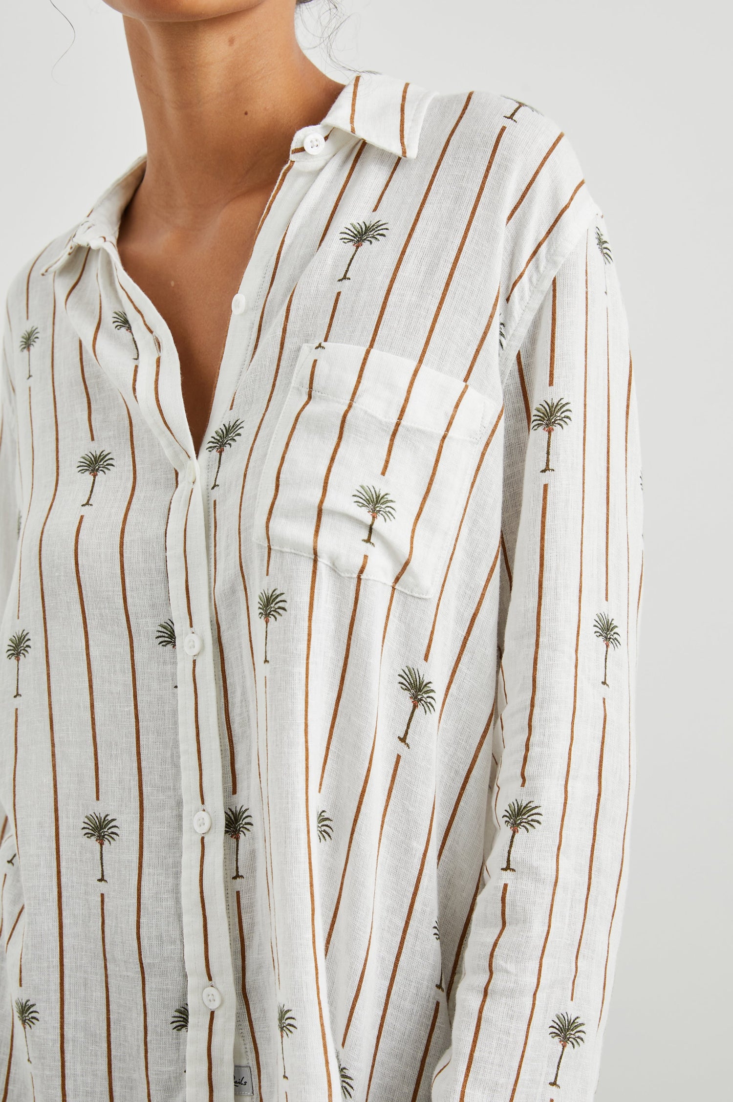 Charli Long-Sleeve Button up with a Chest Patch Pocket in Stripe Palms Colorway, with brown vertical stripes dashed with palm trees on white - Front View Featured on Model