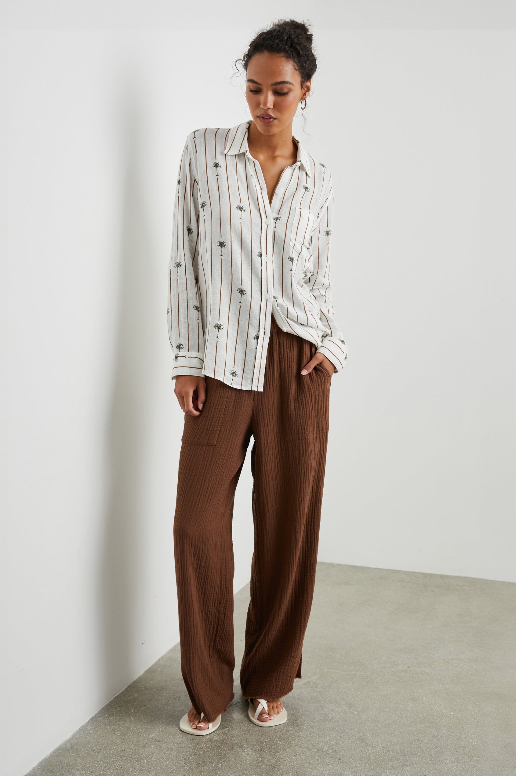 Charli Long-Sleeve Button up with a Chest Patch Pocket in Stripe Palms Colorway, with brown vertical stripes dashed with palm trees on white - Front Full Body View Featured on Model