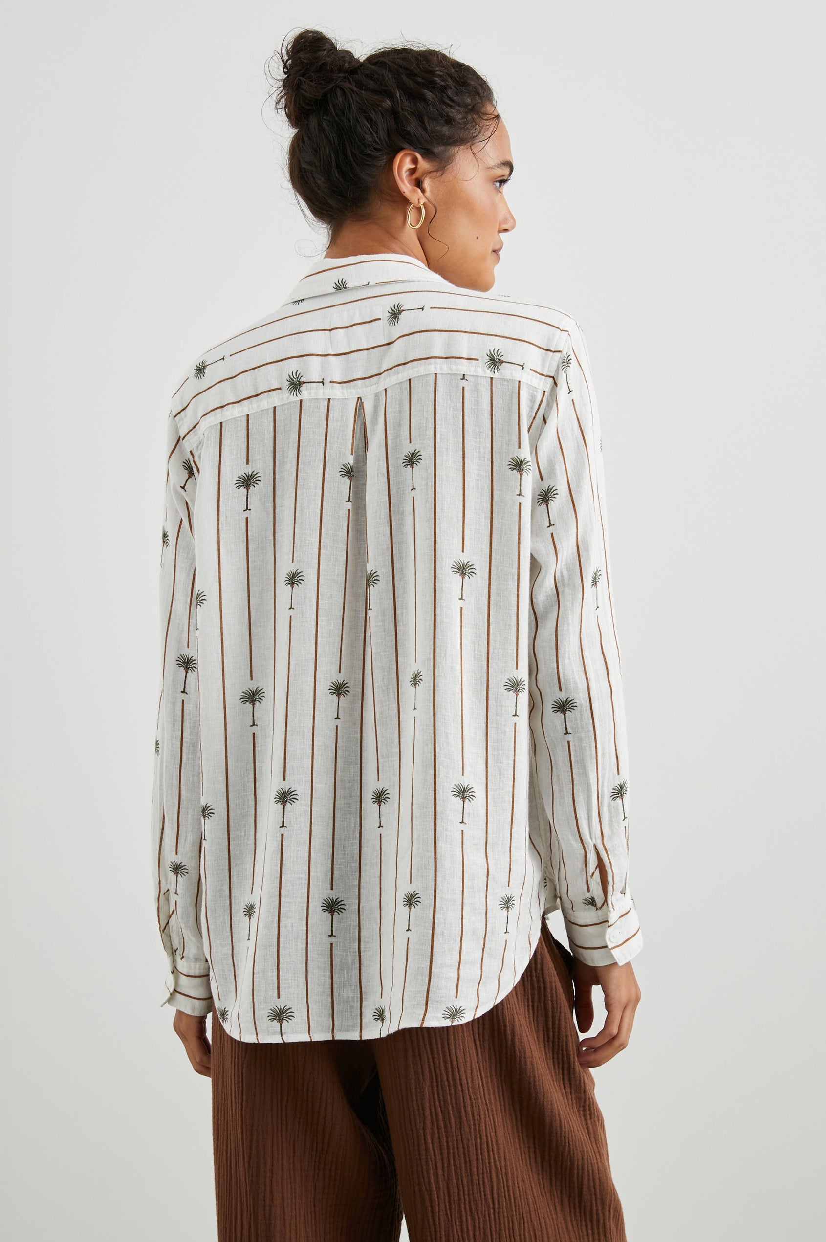 Charli Long-Sleeve Button up with a Chest Patch Pocket in Stripe Palms Colorway, with brown vertical stripes dashed with palm trees on white - Back View Featured on Model