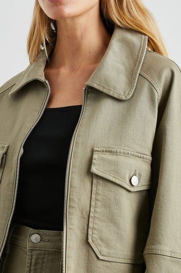 Cheyenne Denim Zip-Up Jacket with Two Chest Buttoned Flap Pockets in Washed Olive Colorway - Front View Featured on Model 