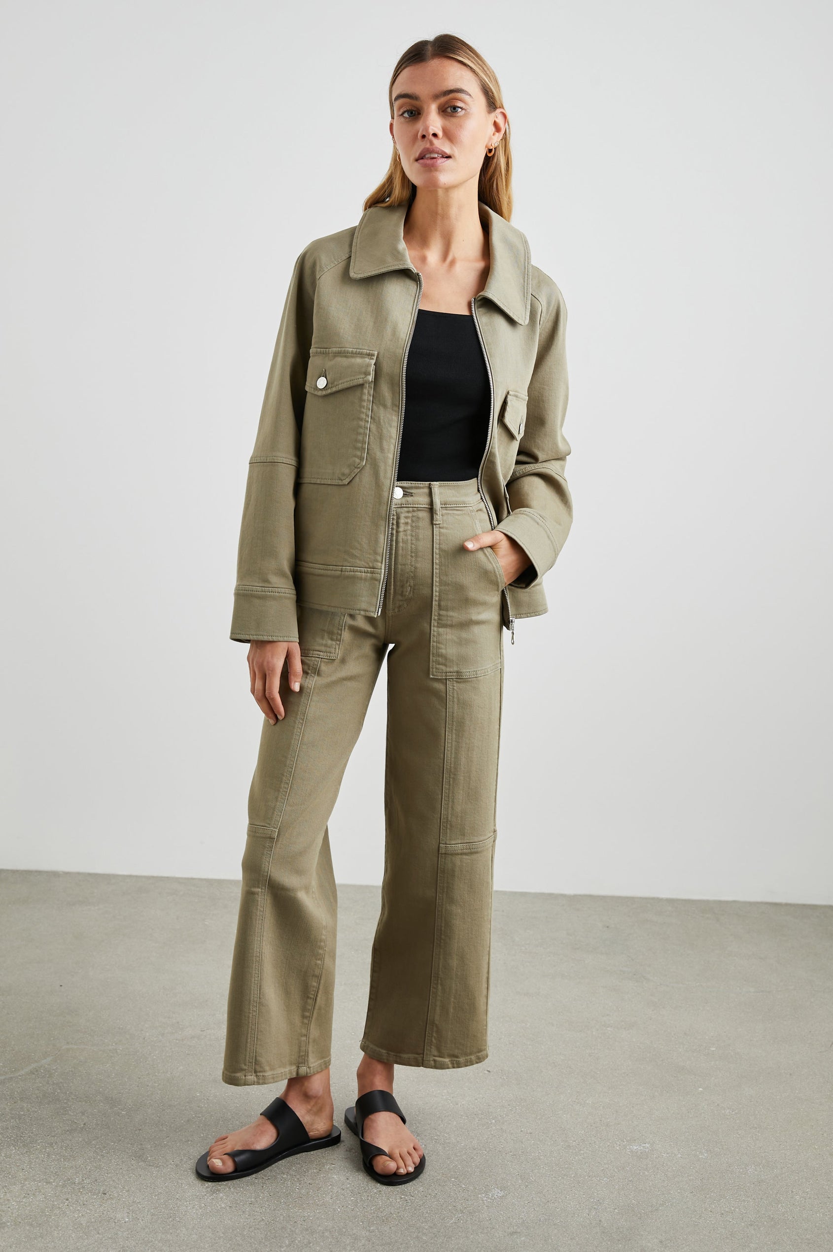 Cheyenne Denim Zip-Up Jacket with Two Chest Buttoned Flap Pockets in Washed Olive Colorway - Front Full Body View Featured on Model 