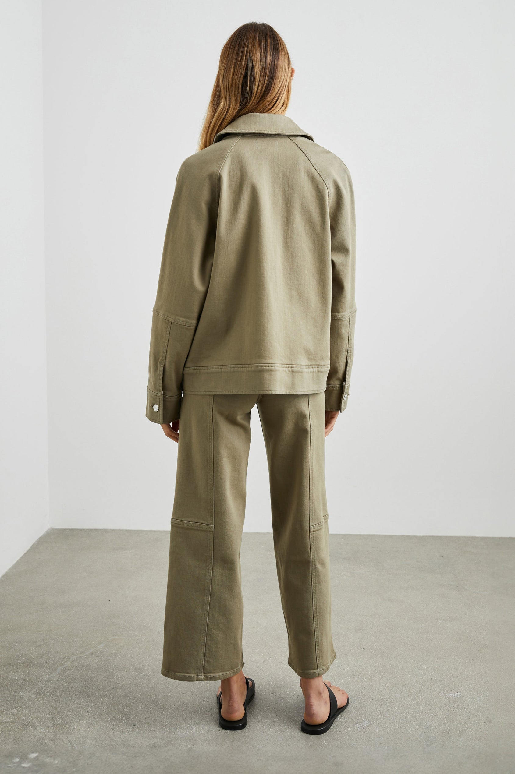 Cheyenne Denim Zip-Up Jacket with Two Chest Buttoned Flap Pockets in Washed Olive Colorway - Back Full Body View Featured on Model 