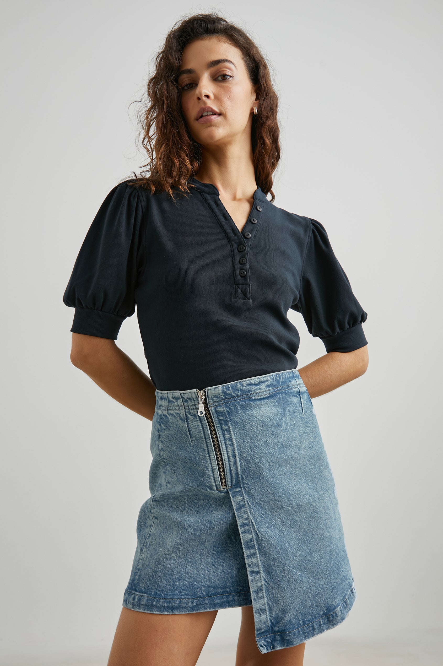 Cienega Denim Mini Skirt with an Asymmetrical Hem and a Wrap Appearance with a Diagonal Zipper in Geranium Colorway - Front View Featured on Model 