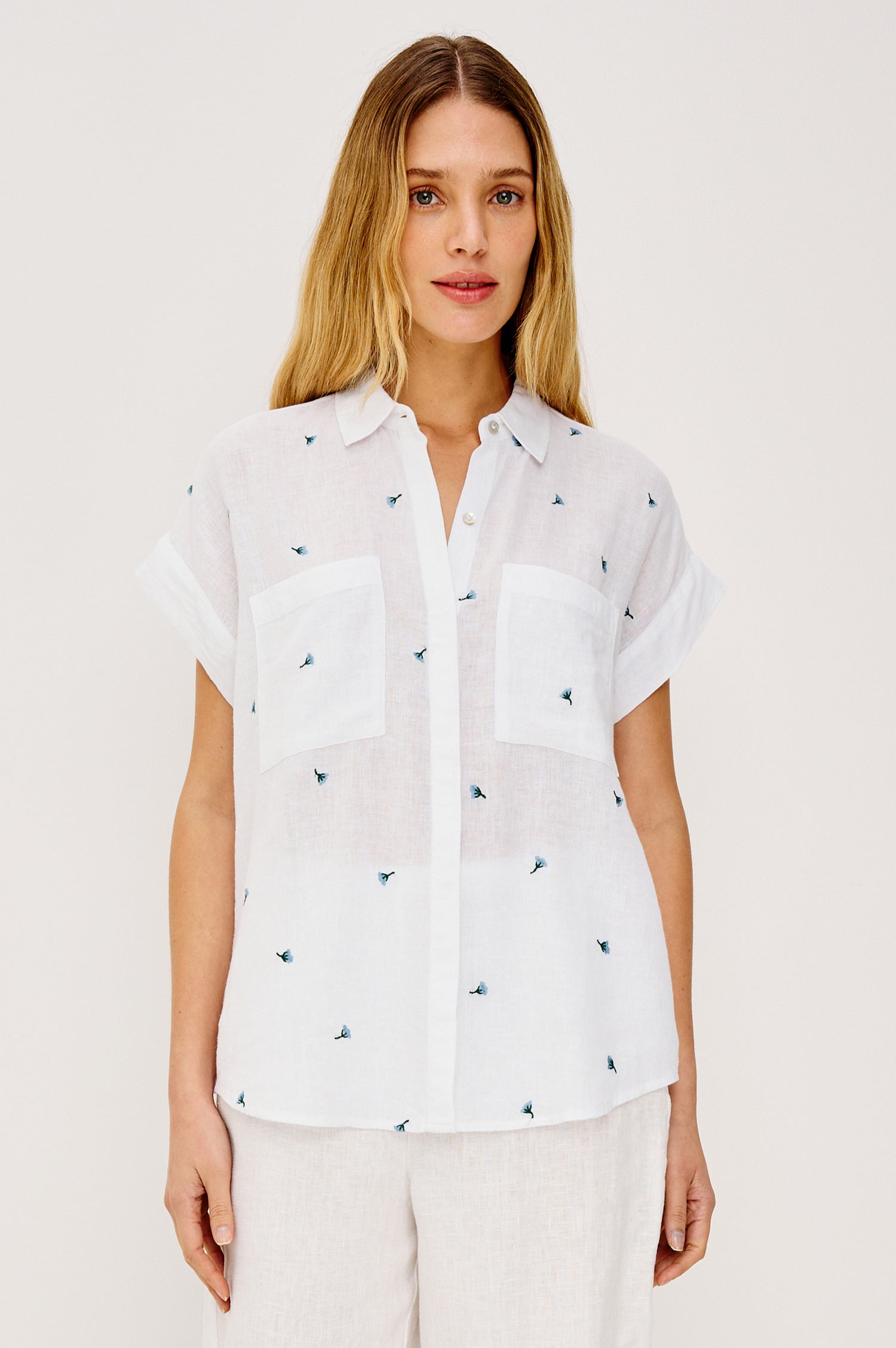 Cito Relaxed Button-Up Shirt in Linen With Collar, Chest Patch Pockets, and Cuffed Cap Sleeves in Bluebell Carnations Colorway - Upper Body Front View Featured on Model