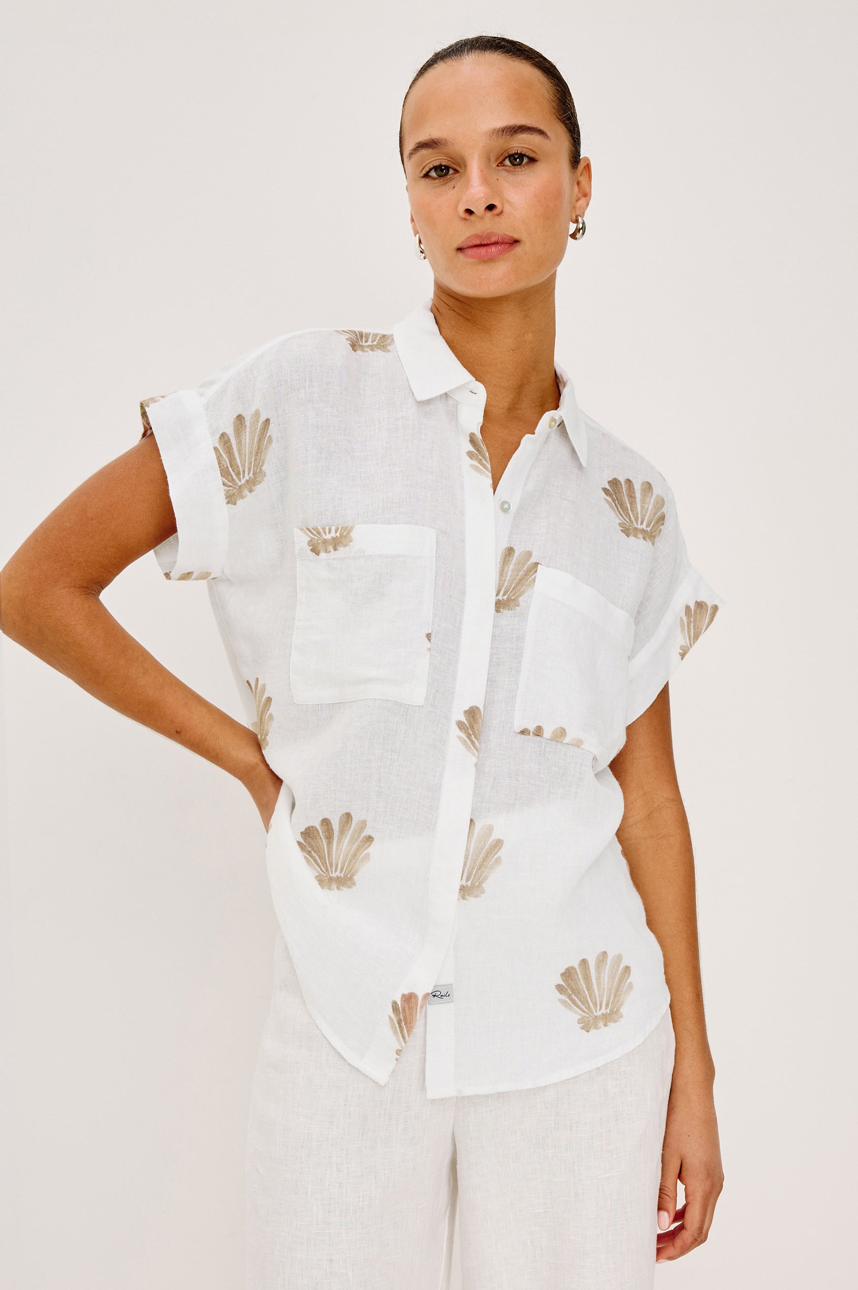 Cito Relaxed Button-Up Shirt in Linen With Collar, Chest Patch Pockets, and Cuffed Cap Sleeves in Taupe Seashells Colorway - Upper Body Front View Featured on Model