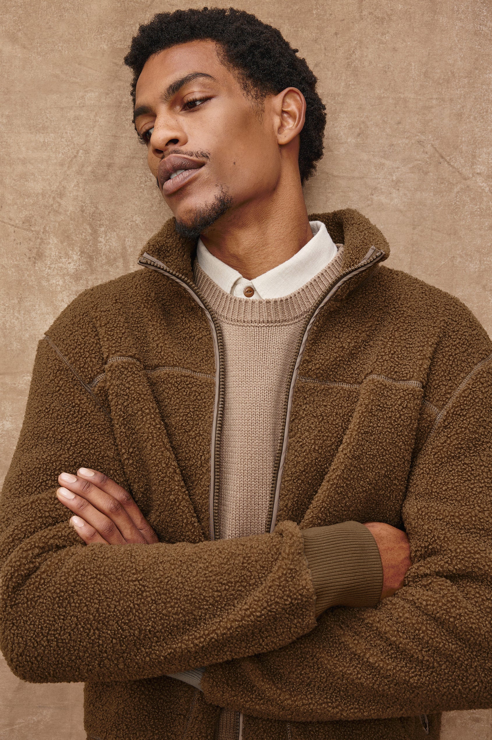 The Clark is a zip front brushed back polar fleece and details include contrast stitching, two zipper pockets, and contrast  grey ribbed cuffs in Lichen colorway. Front detail view featured on model.