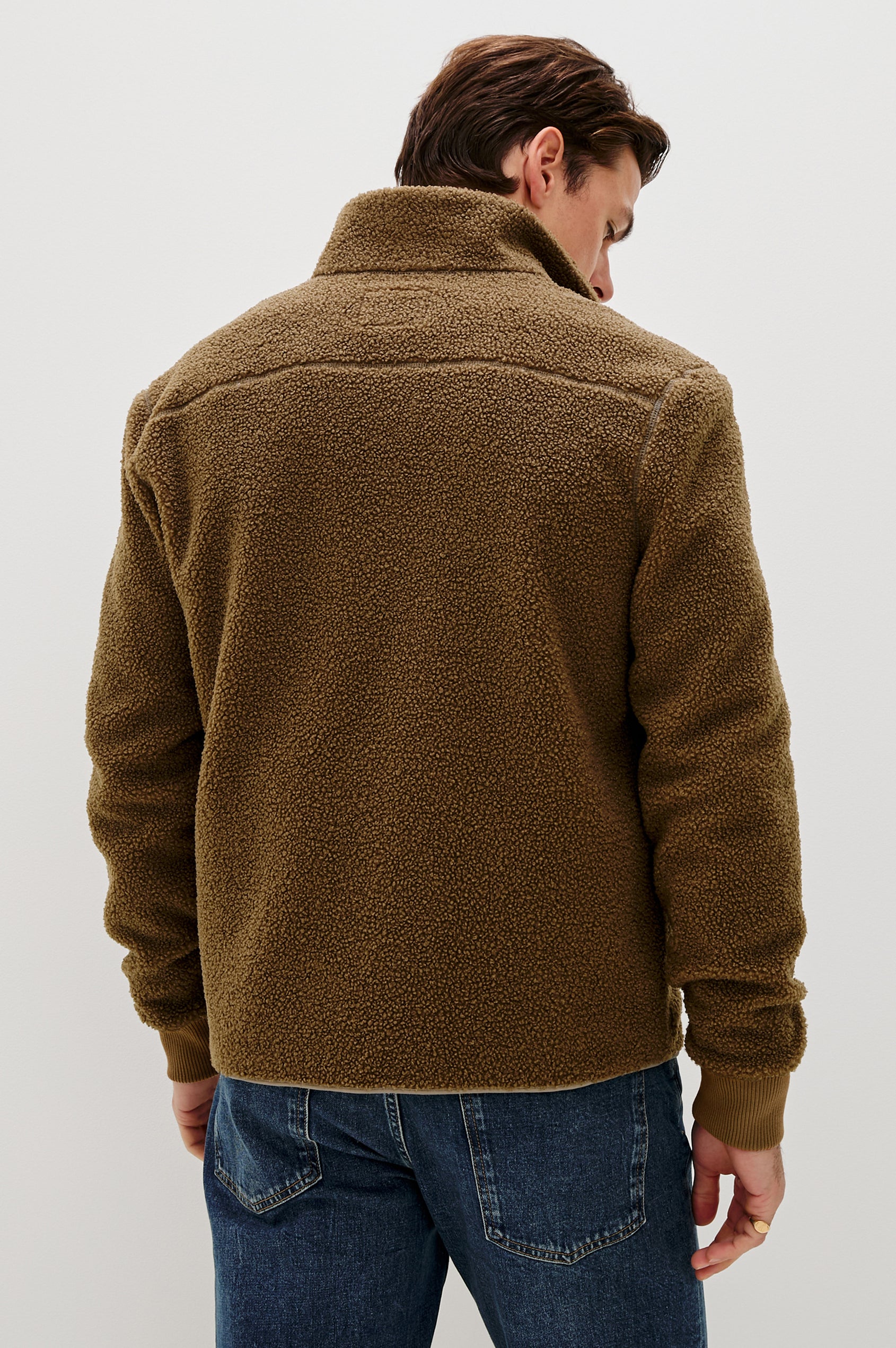 The Clark is a zip front brushed back polar fleece and details include contrast stitching, two zipper pockets, and contrast  grey ribbed cuffs in Lichen colorway. Back view featured on model.
