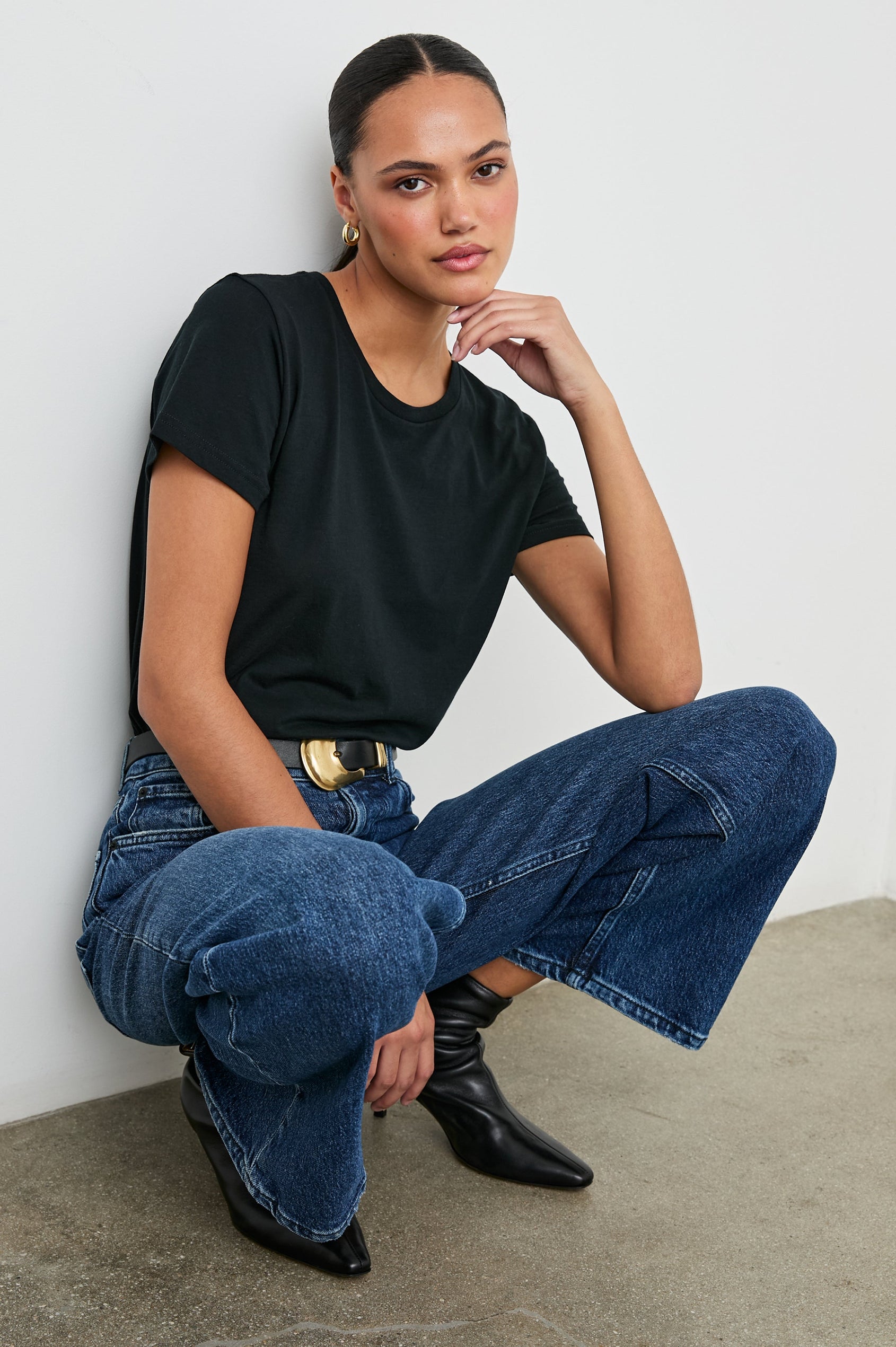 Classic Short Sleeve Crew Neck T-Shirt in Black Colorway - Front Tucked Full Body View Featured on Seated Model