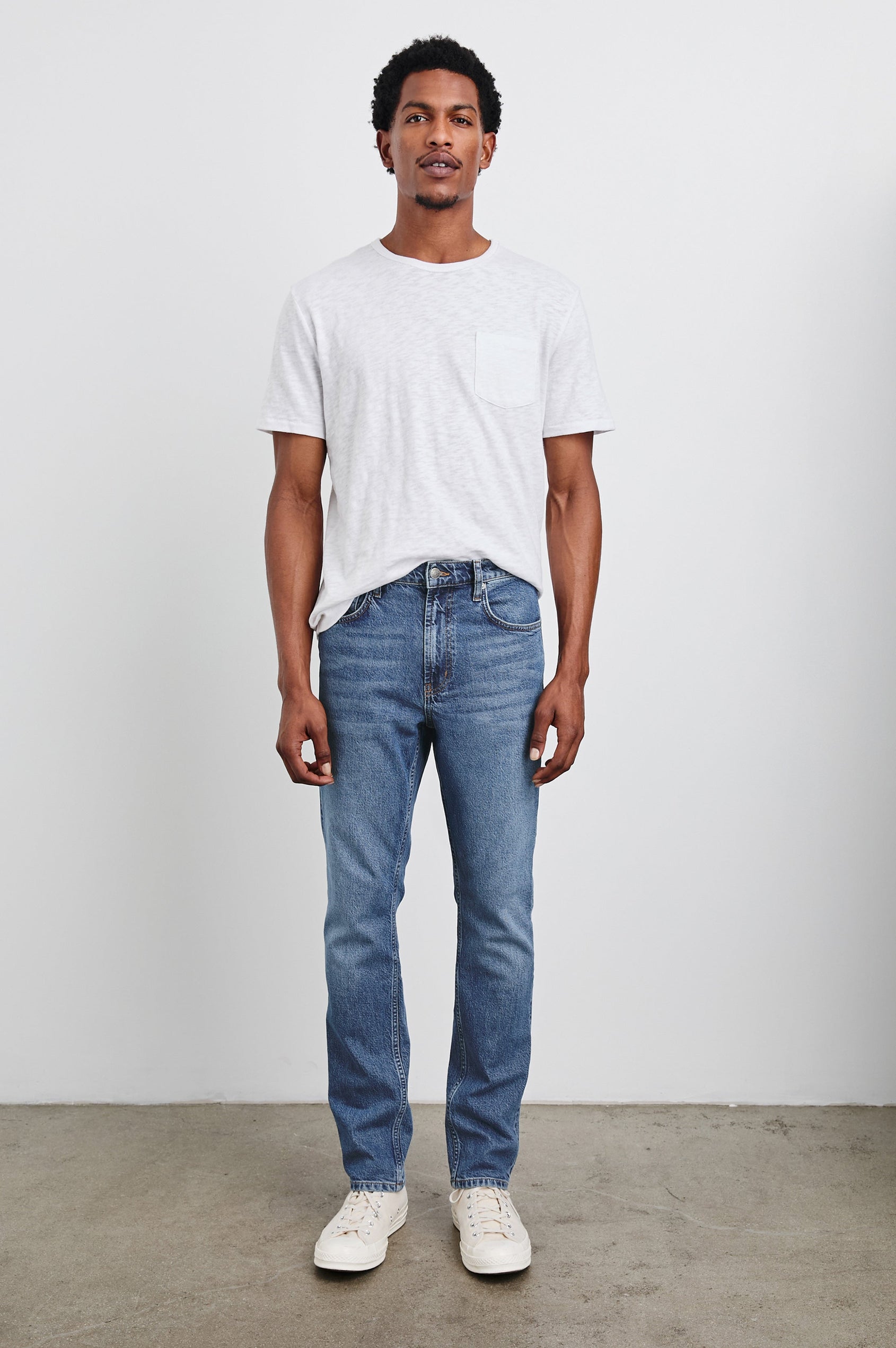 Clayton Slim Straight Jeans with Belt Loops, Two Front Pockets plus a Coin Pocket and Two Back Patch Pockets in Authentic 10 Year Colorway, a Blue - Front Full Body View Featured on Model