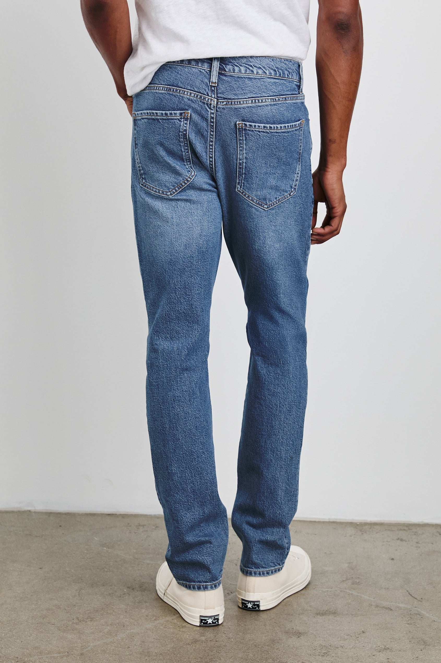 Clayton Slim Straight Jeans with Belt Loops, Two Front Pockets plus a Coin Pocket and Two Back Patch Pockets in Authentic 10 Year Colorway, a Blue - Back View Featured on Model