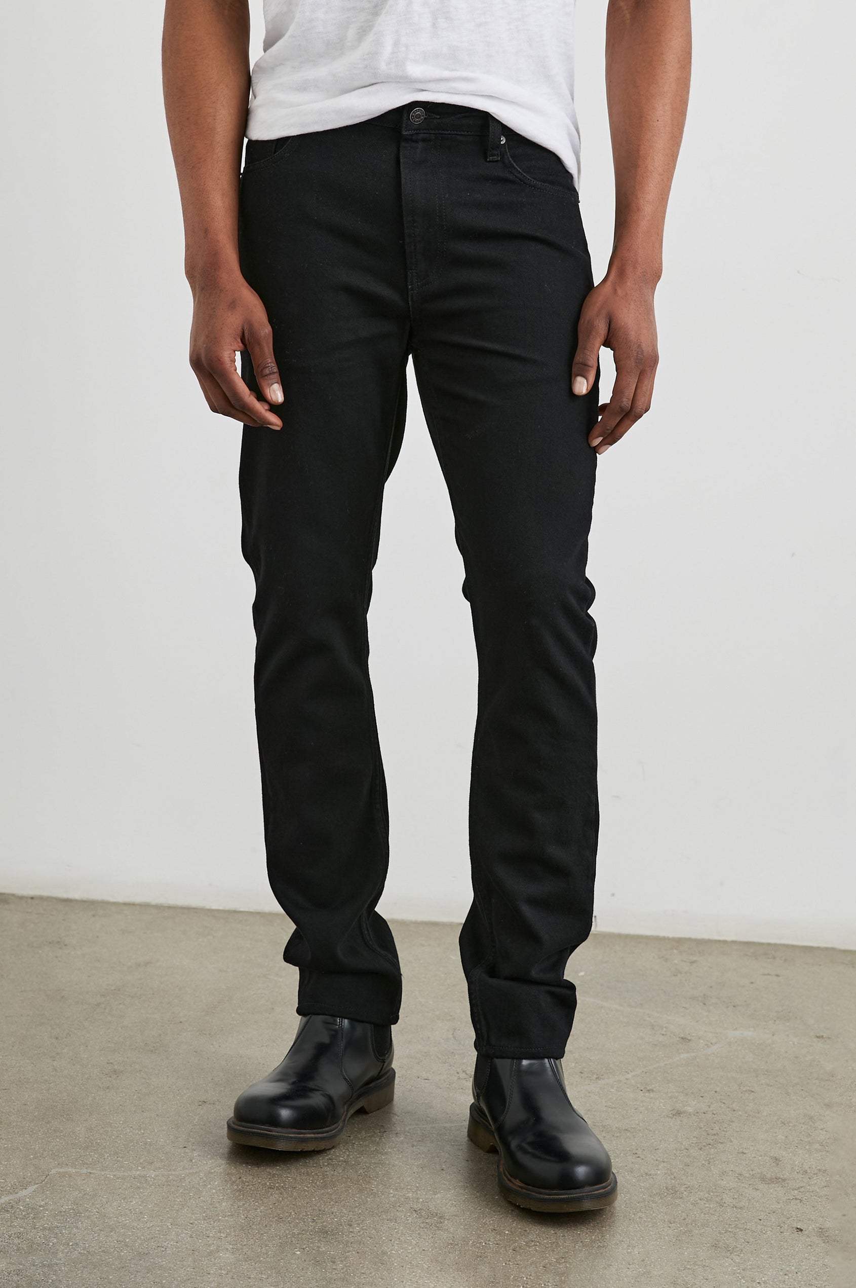 Clayton Slim Straight Jeans with Belt Loops, Two Front Pockets plus a Coin Pocket and Two Back Patch Pockets in Dark Black Colorway - Front View Featured on Model