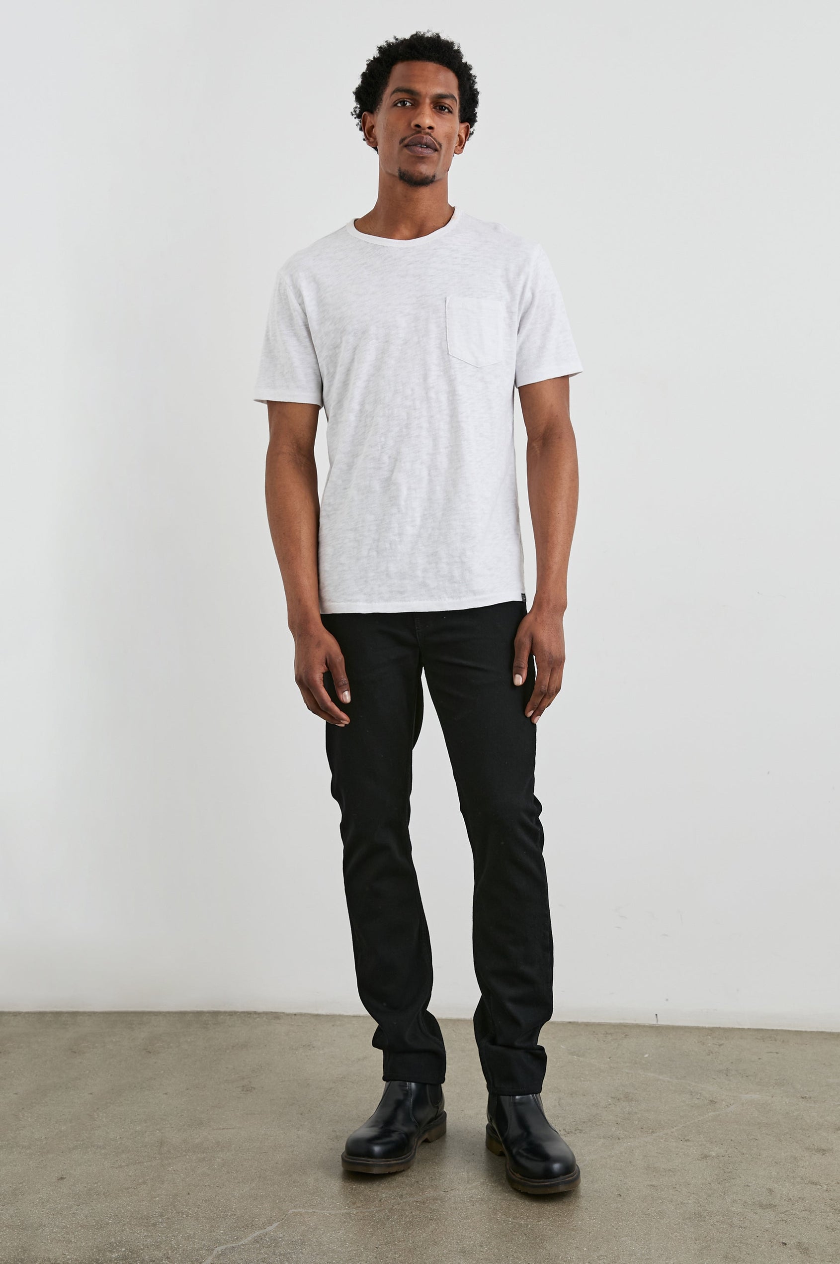Clayton Slim Straight Jeans with Belt Loops, Two Front Pockets plus a Coin Pocket and Two Back Patch Pockets in Dark Black Colorway - Front Full Body View Featured on Model