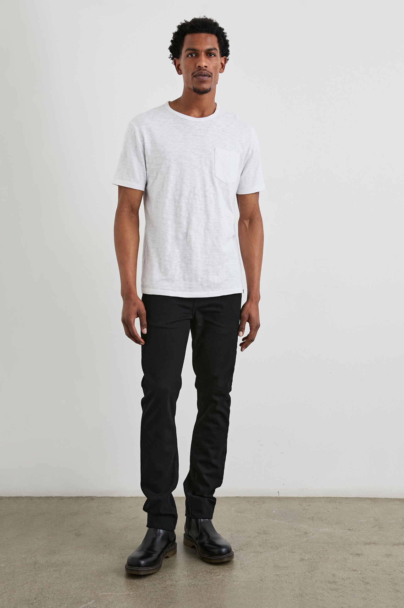 Clayton Slim Straight Jeans with Belt Loops, Two Front Pockets plus a Coin Pocket and Two Back Patch Pockets in Dark Black Colorway - Front Full Body View Featured on Model