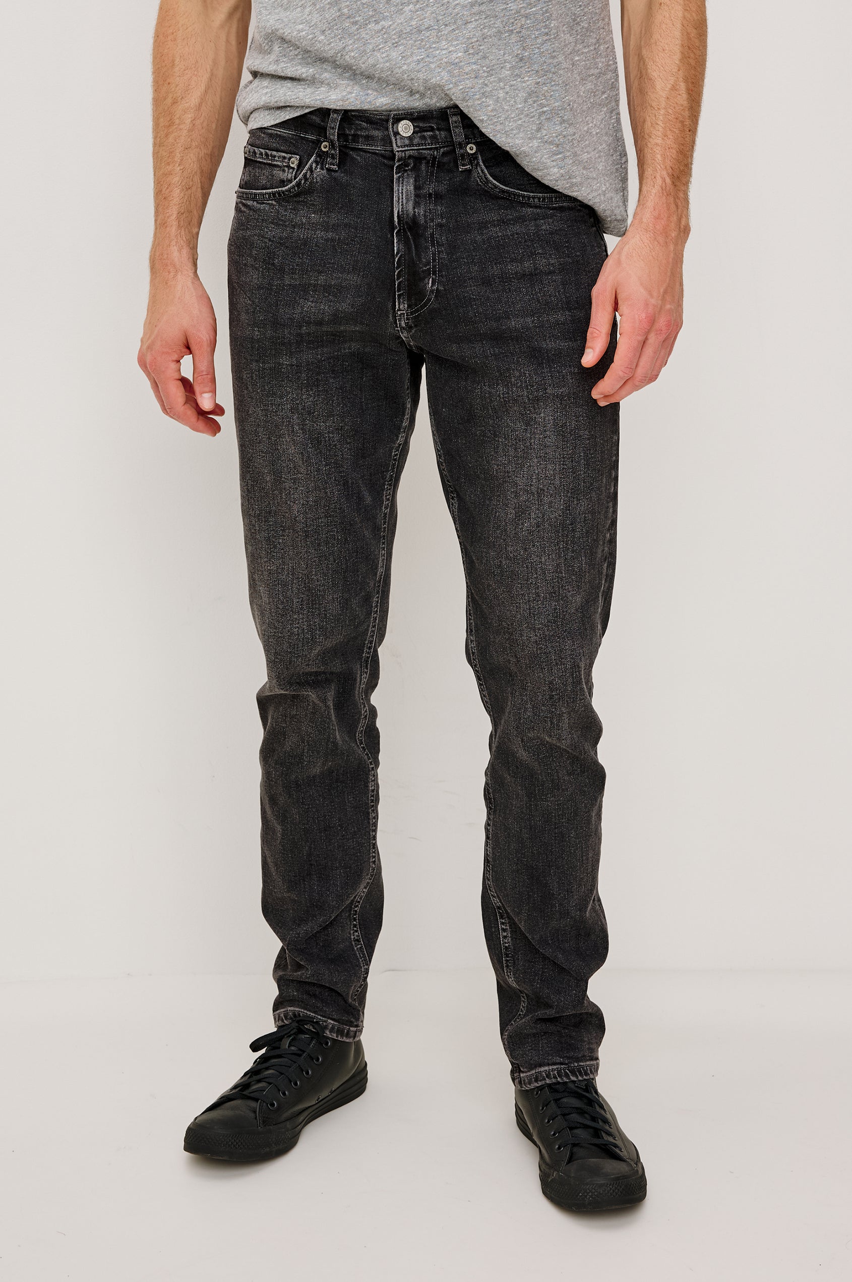 Clayton Slim Straight is a Classic 5-Pocket Jean in Faded Onyx Colorway, a Washed Black. Front View Featured on Model.